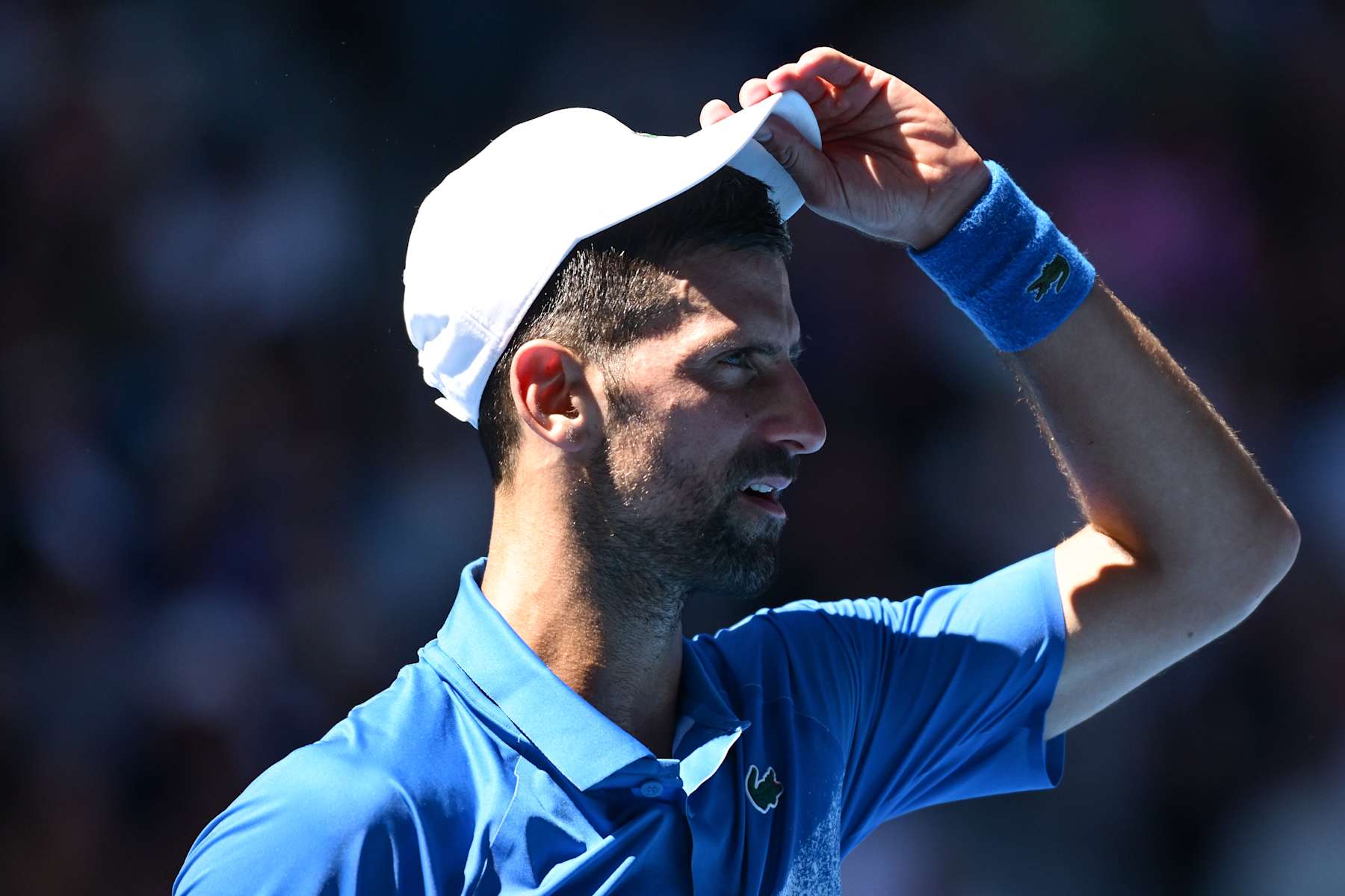 MELBOURNE, AUSTRALIA - JANUARY 24: Novak Djokovic of Serbia reacts in the Men's Singles Semifinal against Alexander Zverev of Germany during day 13 of the 2025 Australian Open at Melbourne Park on January 24, 2025 in Melbourne, Australia. (Photo by Hannah Peters/Getty Images)