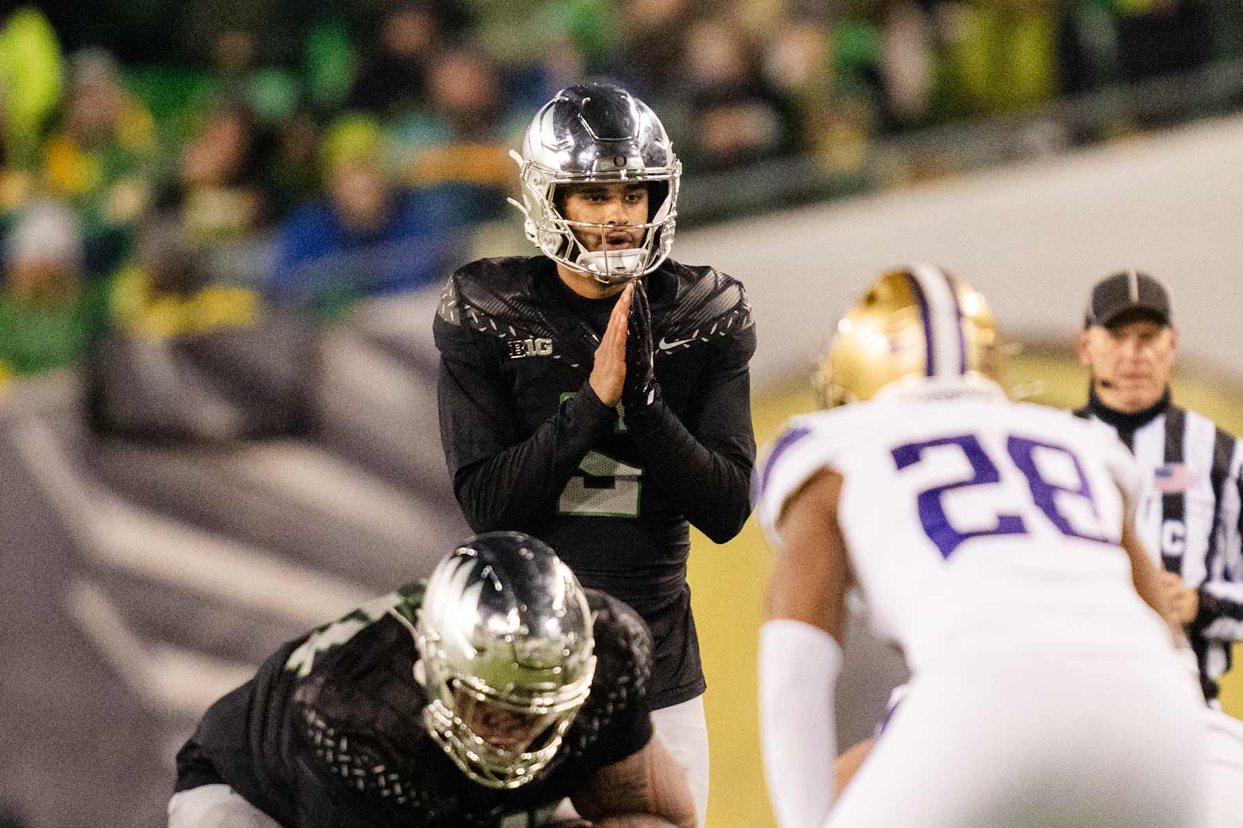 EUGENE, OREGON - NOVEMBER 30: Quarterback Dante Moore #5 of the Oregon Ducks calls out a play during the second half of the game against the Washington Huskies at Autzen Stadium on November 30, 2024 in Eugene, Oregon. (Photo by Ali Gradischer/Getty Images)