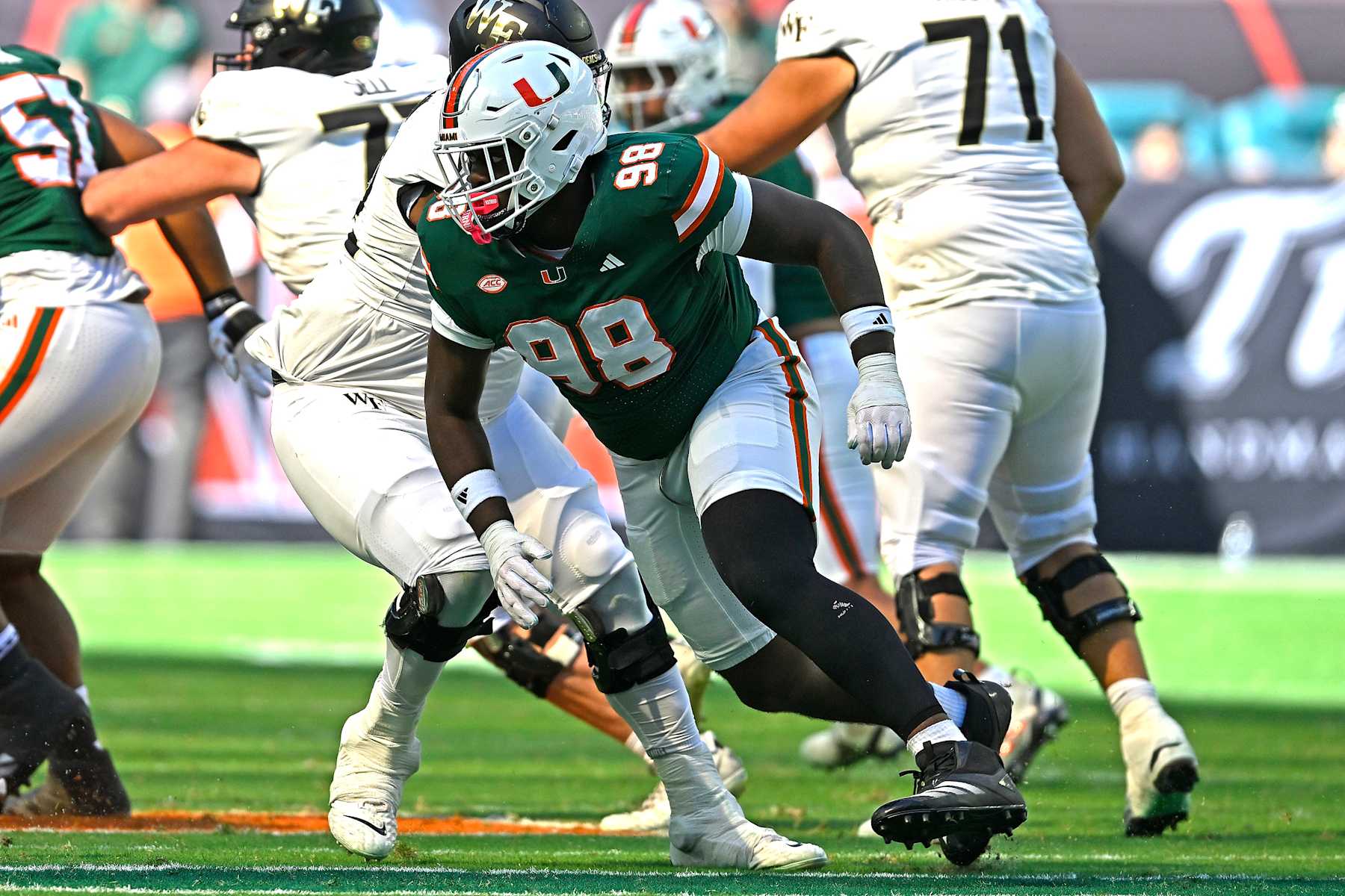 MIAMI GARDENS, FL - NOVEMBER 23: Miami defensive lineman Justin Scott (98) pursues the ball carrier in the second quarter as the Miami Hurricanes faced the Wake Forest Demon Deacons on November 23, 2024, at Hard Rock Stadium in Miami Gardens, Florida. (Photo by Samuel Lewis/Icon Sportswire via Getty Images)
