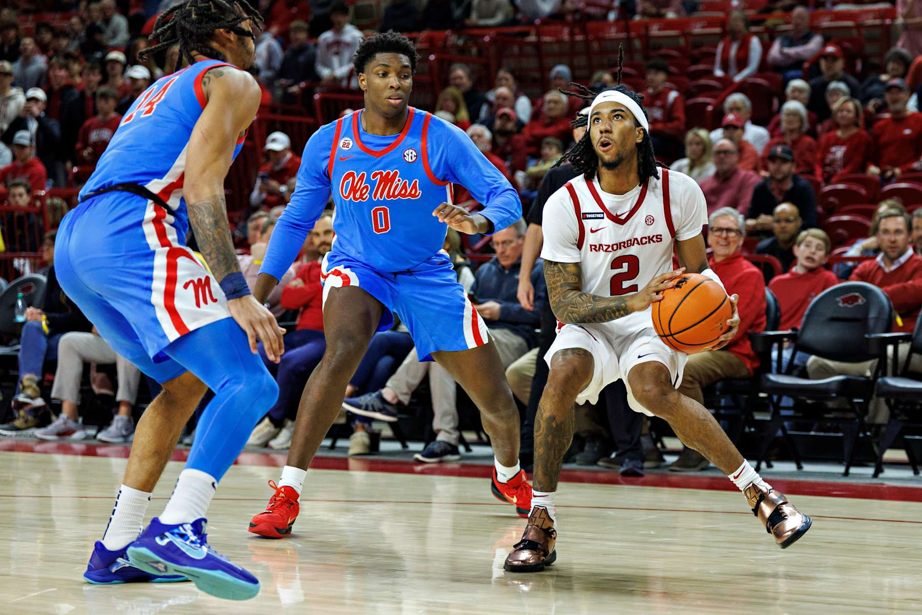 FAYETTEVILLE, ARKANSAS - JANUARY 08: Boogie Fland #2 of the Arkansas Razorbacks looks to take a shot against Malik Dia #0 and Dre Davis #4 of the Ole Miss Rebels at Bud Walton Arena on January 08, 2025 in Fayetteville, Arkansas. The Rebels defeated the Razorbacks 73-66. (Photo by Wesley Hitt/Getty Images)