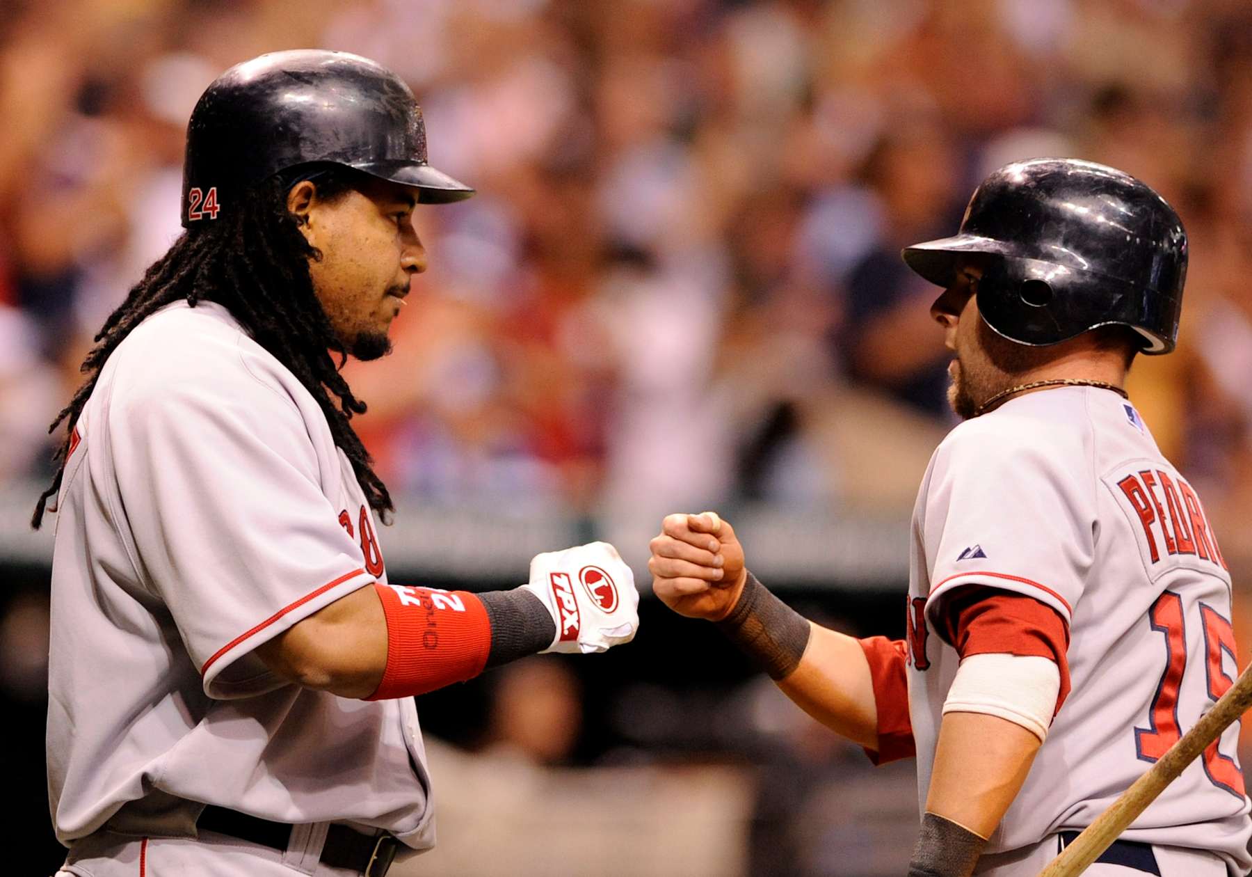 ST PETERSBURG, FL - JULY 2: Infielder Dustin Pedroia #15 and designated hitter Manny Ramirez #24 of the Boston Red Sox celebrate a run against the Tampa Bay Rays July 2, 2008 at Tropicana Field in St. Petersburg, Florida. (Photo by Al Messerschmidt/Getty Images)