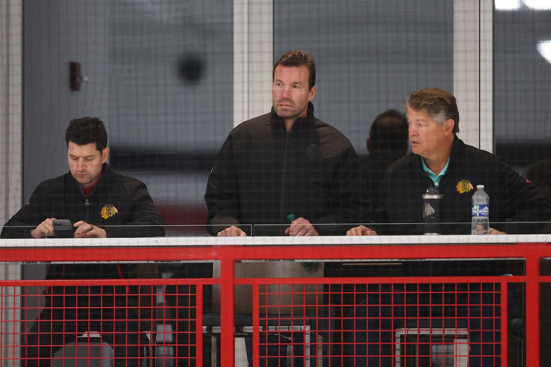 CHICAGO, ILLINOIS - SEPTEMBER 14: (L-R) General manager Kyle Davidson, head coach Luke Richardson and assistant coach Kevin Dean of the Chicago Blackhawks look on during Prospect Camp practice at Fifth Third Arena on September 14, 2023 in Chicago, Illinois. (Photo by Michael Reaves/Getty Images)