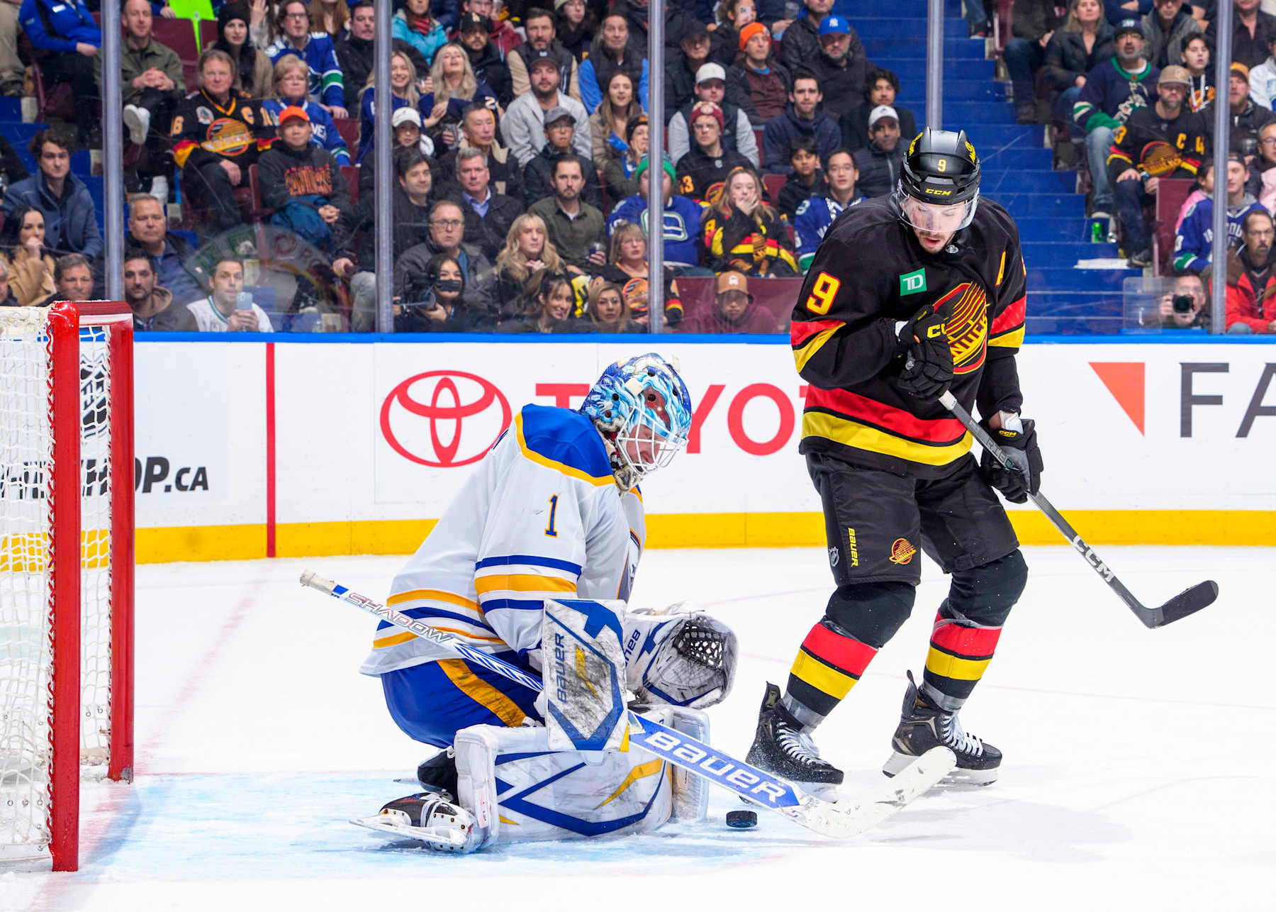VANCOUVER, CANADA - JANUARY 21: Ukko-Pekka Luukkonen #1 of the Buffalo Sabres blocks a shot from J.T. Miller #9 of the Vancouver Canucks during the third period of their NHL game at Rogers Arena on January 21, 2025 in Vancouver, British Columbia, Canada. (Photo by Jeff Vinnick/NHLI via Getty Images)