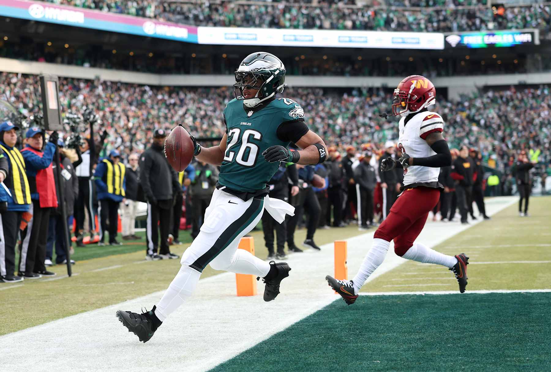 PHILADELPHIA, PENNSYLVANIA - JANUARY 26: Saquon Barkley #26 of the Philadelphia Eagles scores a 4 yard touchdown against the Washington Commanders during the first quarter in the NFC Championship Game at Lincoln Financial Field on January 26, 2025 in Philadelphia, Pennsylvania. (Photo by Emilee Chinn/Getty Images)