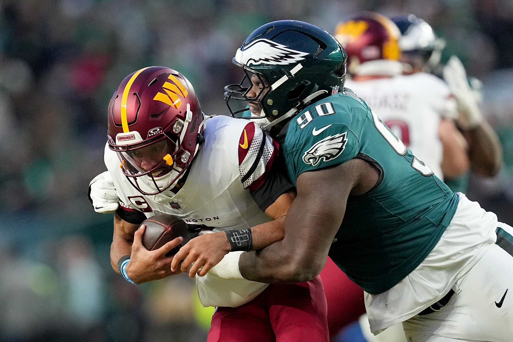 PHILADELPHIA, PENNSYLVANIA - JANUARY 26: Jordan Davis #90 of the Philadelphia Eagles sacks Jayden Daniels #5 of the Washington Commanders during the third quarter in the NFC Championship Game at Lincoln Financial Field on January 26, 2025 in Philadelphia, Pennsylvania.  (Photo by Mitchell Leff/Getty Images)