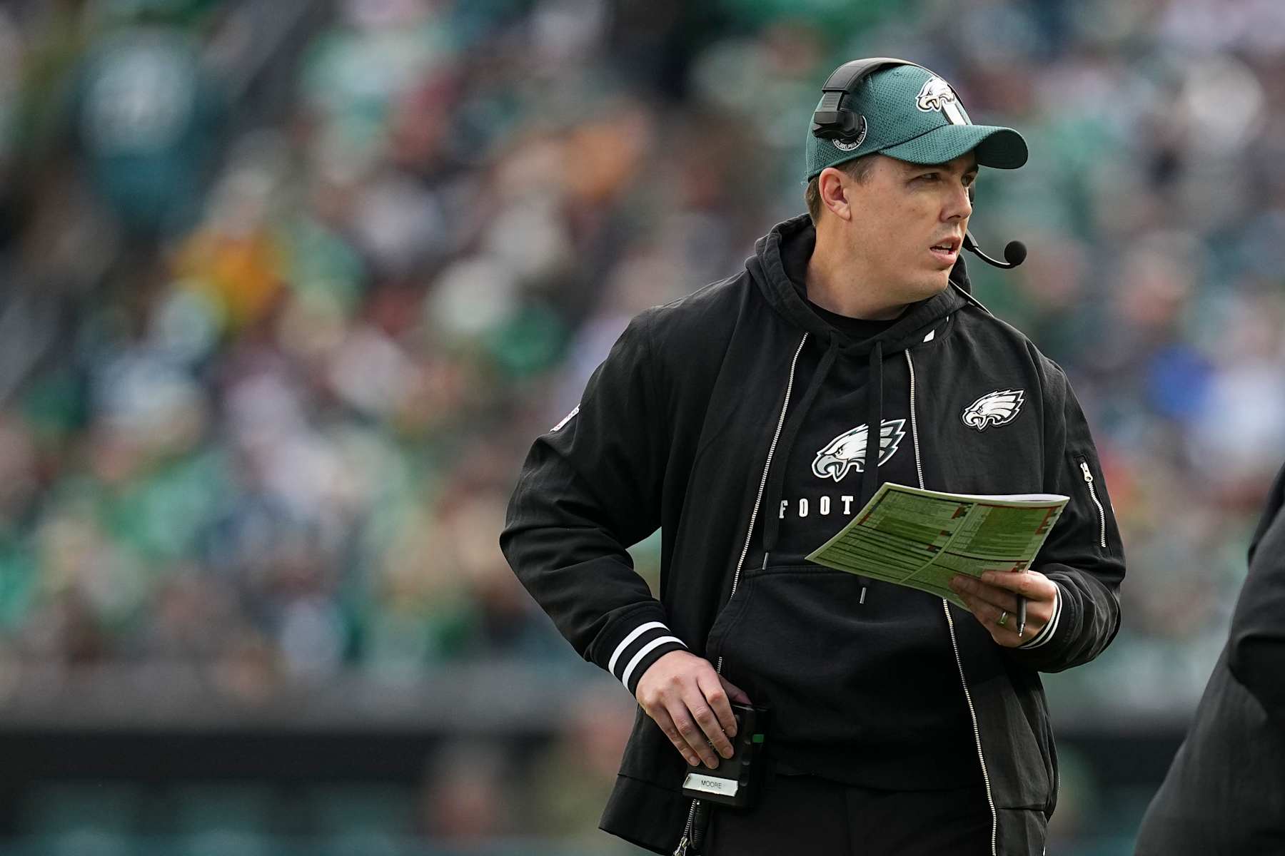 PHILADELPHIA, PENNSYLVANIA - DECEMBER 8: Offensive coordinator Kellen Moore of the Philadelphia Eagles looks on against the Carolina Panthers at Lincoln Financial Field on December 8, 2024 in Philadelphia, Pennsylvania. (Photo by Mitchell Leff/Getty Images)