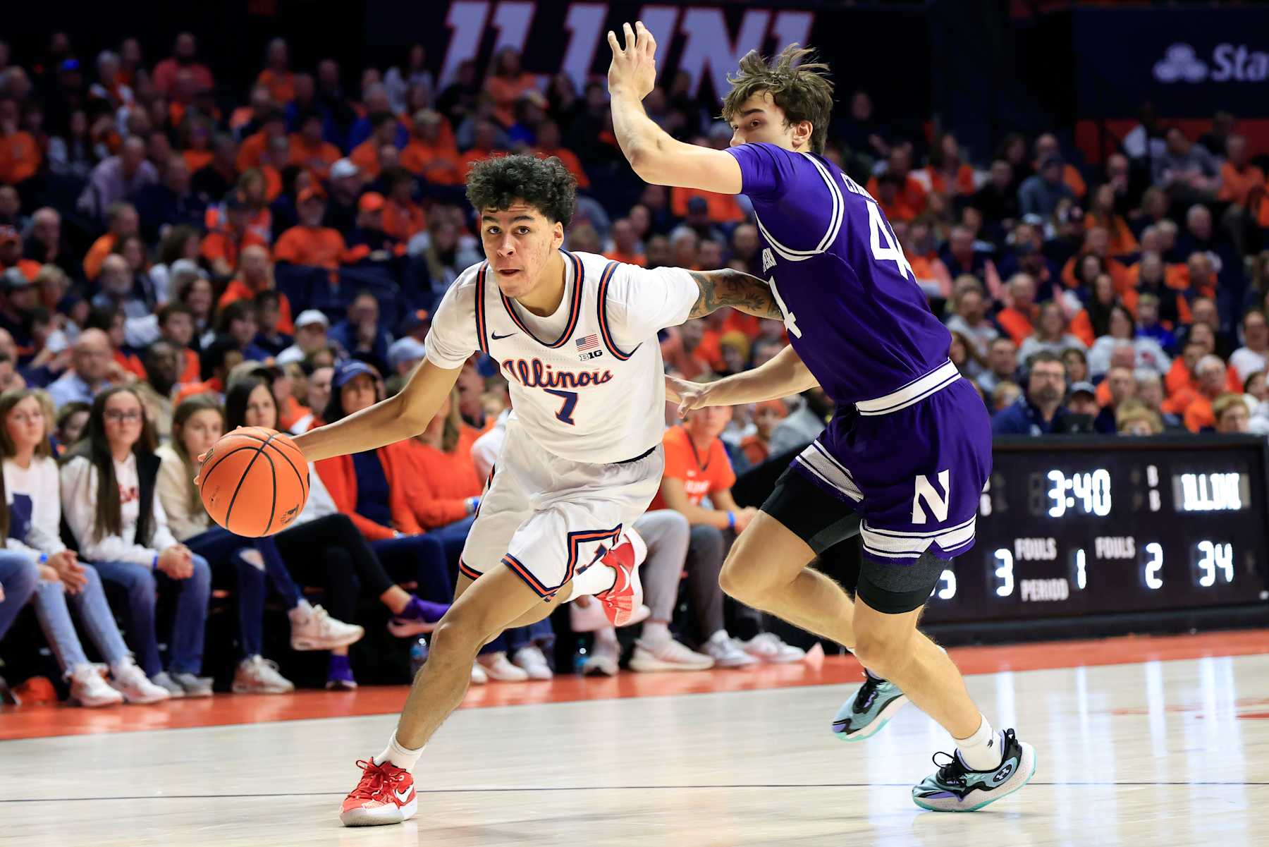 CHAMPAIGN, ILLINOIS - JANUARY 26: Will Riley #7 of the Illinois Fighting Illini drives to the basket against Angelo Ciaravino #44 of the Northwestern Wildcats during the first half at State Farm Center on January 26, 2025 in Champaign, Illinois. (Photo by Justin Casterline/Getty Images)