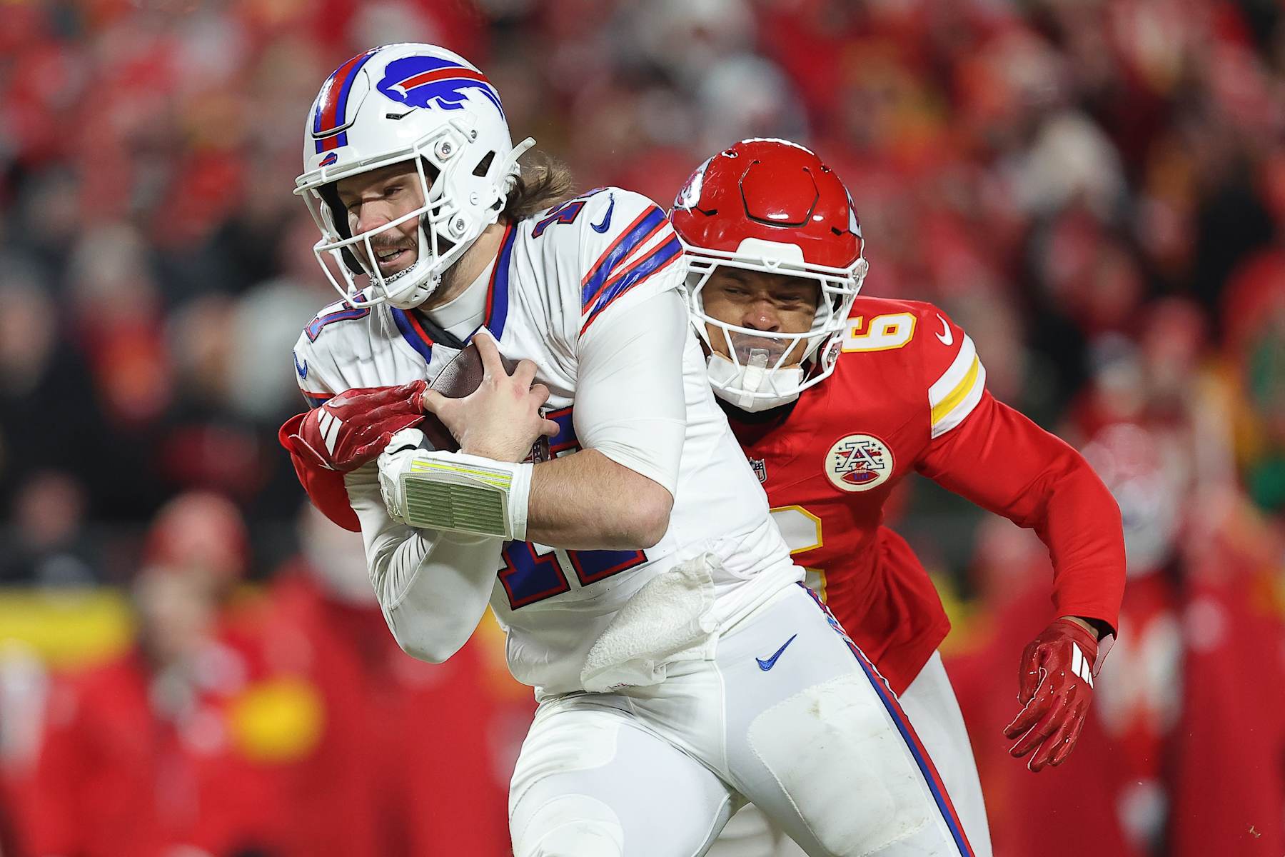 KANSAS CITY, MISSOURI - JANUARY 26: Josh Allen #17 of the Buffalo Bills avoids a tackle by Bryan Cook #6 of the Kansas City Chiefs during the third quarter in the AFC Championship Game at GEHA Field at Arrowhead Stadium on January 26, 2025 in Kansas City, Missouri.  (Photo by David Eulitt/Getty Images)