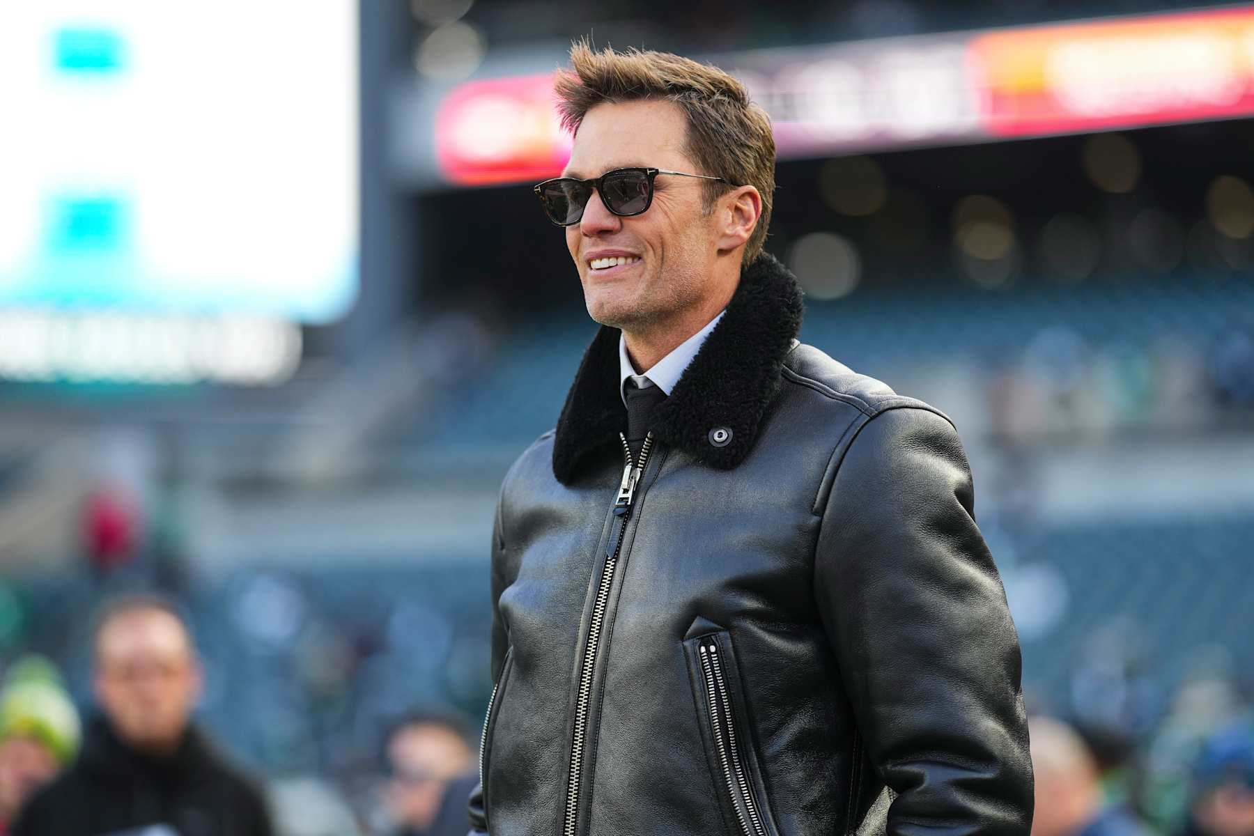 PHILADELPHIA, PA - JANUARY 12:  Tom Brady looks on from the field during warmups prior to an NFL football wild card playoff game between the Green Bay Packers and the Philadelphia Eagles at Lincoln Financial Field on January 12, 2025 in Philadelphia, Pennsylvania. (Photo by Cooper Neill/Getty Images)