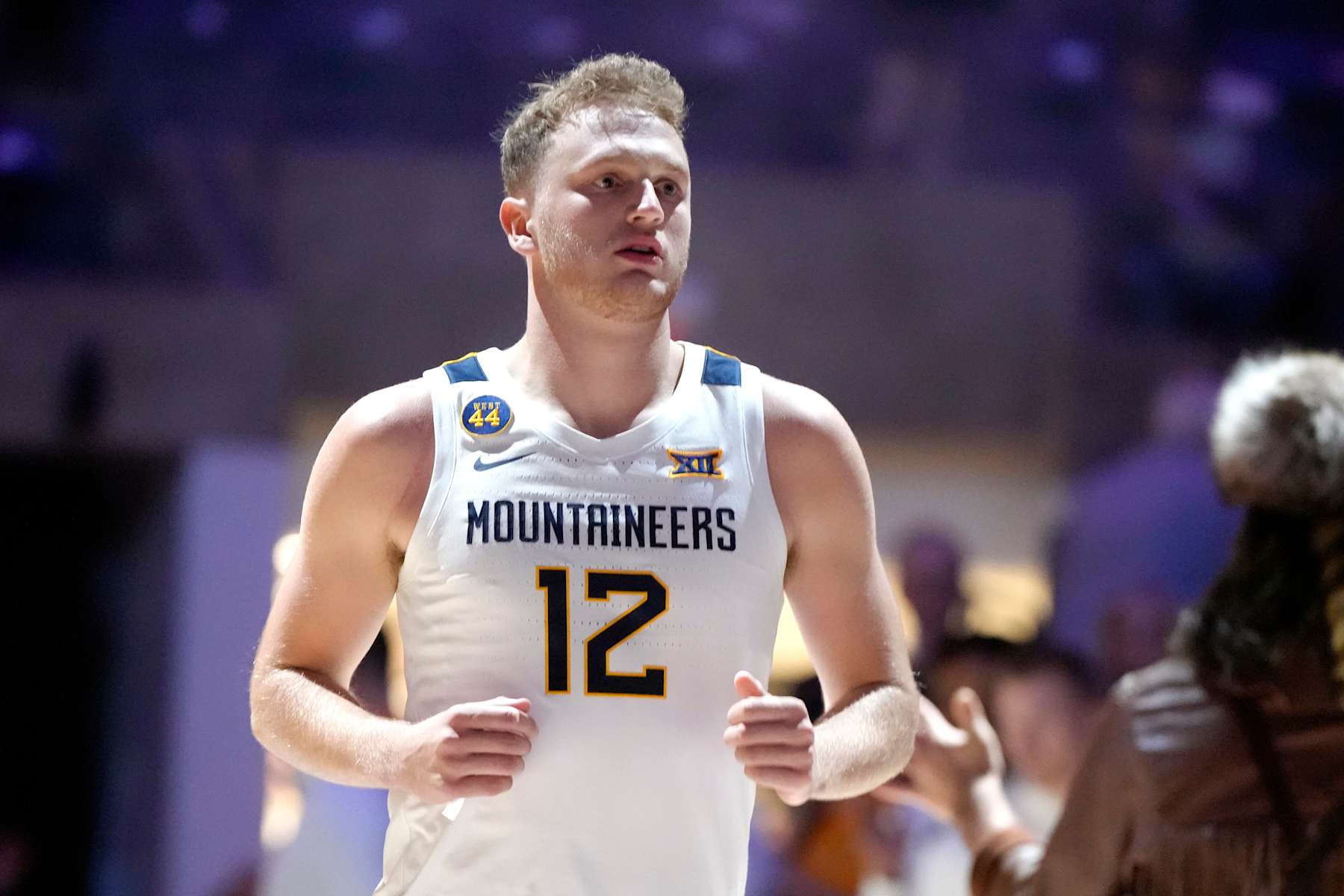 MORGANTOWN, WV- OCTOBER 18: Tucker DeVries #12 of the West Virginia Mountaineers is introduced before an exhibition college basketball game against the Charleston Golden Eagles at WVU Coliseum on October 18, 2024 in Morgantown, West Virginia. (Photo by Mitchell Layton/Getty Images)