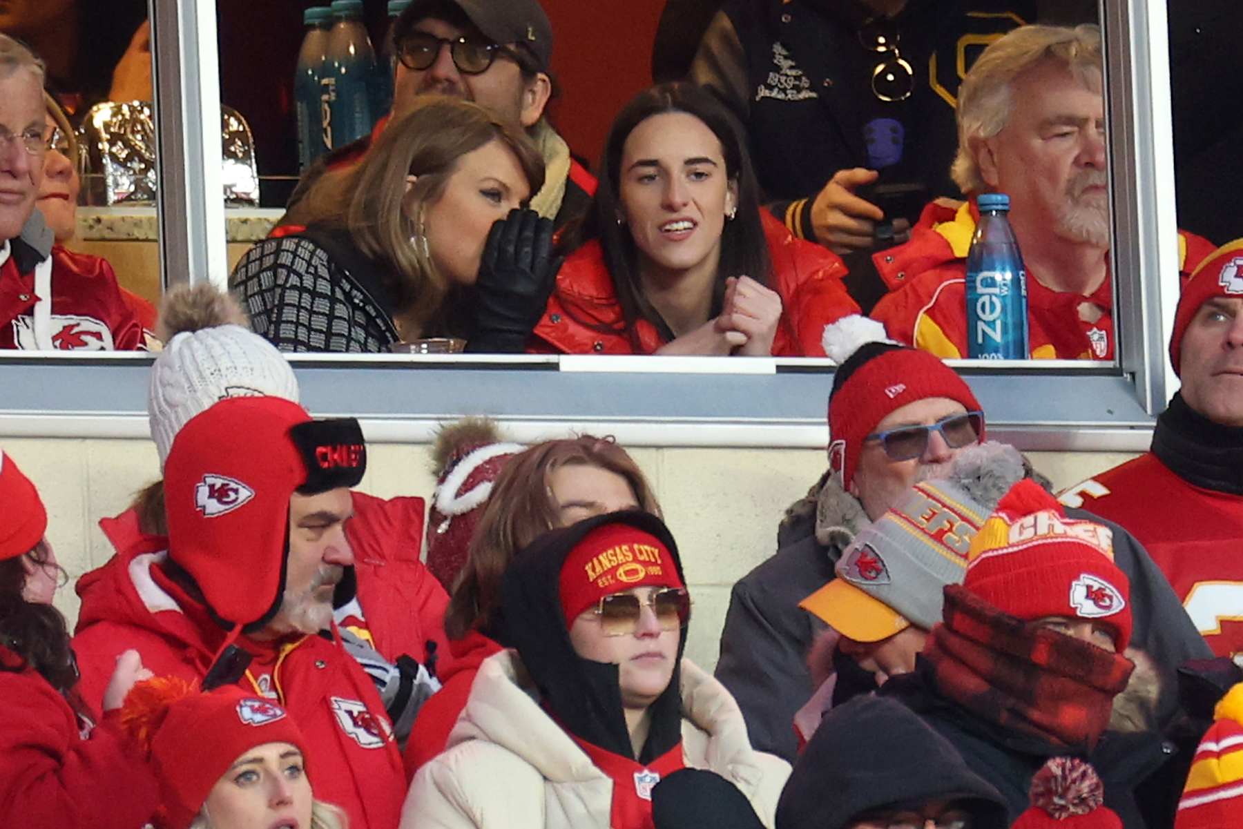 KANSAS CITY, MISSOURI - JANUARY 18: Singer-songwriter Taylor Swift (L) talks with Caitlin Clark (R) of the Indiana Fever during the second half in the AFC Divisional Playoff between the Houston Texans and the Kansas City Chiefs at GEHA Field at Arrowhead Stadium on January 18, 2025 in Kansas City, Missouri. (Photo by Jamie Squire/Getty Images)