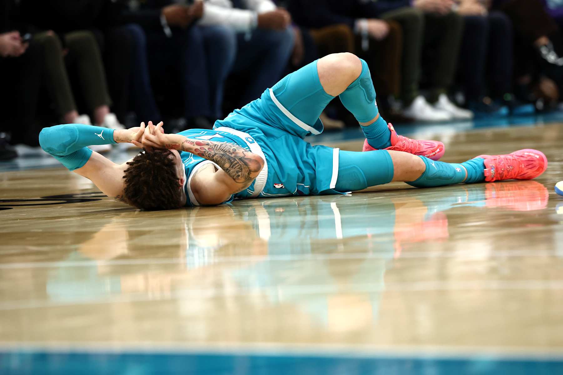 CHARLOTTE, NORTH CAROLINA - JANUARY 27: LaMelo Ball #1 of the Charlotte Hornets falls to the ground following a left ankle sprain after colliding with Jarred Vanderbilt #2 of the Los Angeles Lakers during the second quarter of the game at Spectrum Center on January 27, 2025 in Charlotte, North Carolina. NOTE TO USER: User expressly acknowledges and agrees that, by downloading and or using this photograph, User is consenting to the terms and conditions of the Getty Images License Agreement. (Photo by Jared C. Tilton/Getty Images)