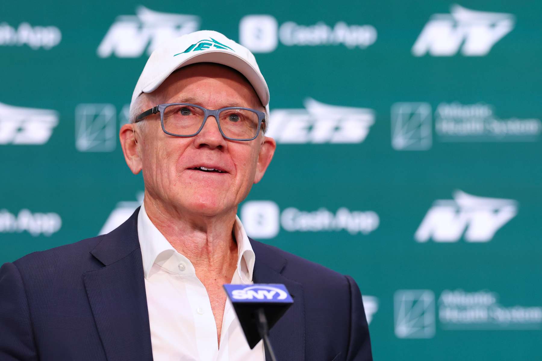 FLORHAM PARK, NEW JERSEY - JANUARY 27: New York Jets owner Woody Johnson speaks at the press conference announcing the hiring of new head coach Aaron Glenn and general manager Darren Mougey at Atlantic Health Jets Training Center on January 27, 2025 in Florham Park, New Jersey. (Photo by Ed Mulholland/Getty Images)