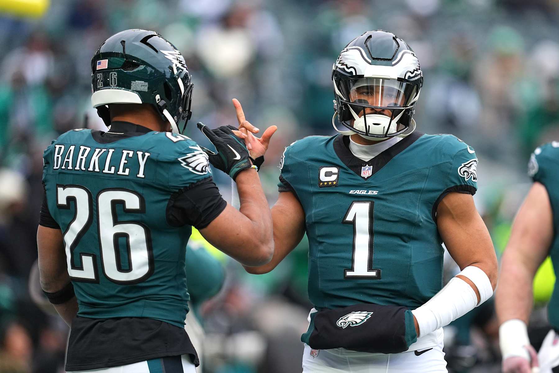PHILADELPHIA, PENNSYLVANIA - JANUARY 26: Jalen Hurts #1 of the Philadelphia Eagles high fives teammate Saquon Barkley #26 prior to the NFC Championship Game against the Washington Commanders at Lincoln Financial Field on January 26, 2025 in Philadelphia, Pennsylvania. (Photo by Mitchell Leff/Getty Images)