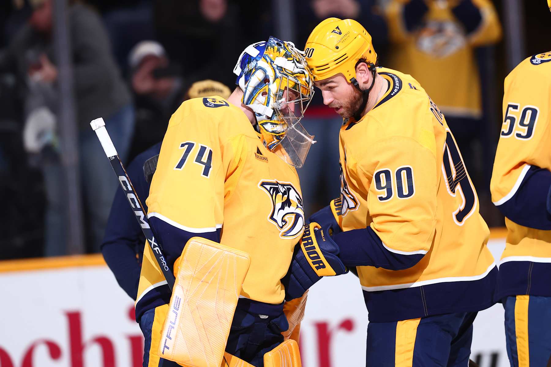 NASHVILLE, TENNESSEE - JANUARY 18: Juuse Saros #74 of the Nashville Predators celebrates a win over the Minnesota Wild with Ryan O'Reilly #90 on January 18, 2025 at Bridgestone Arena in Nashville. (Photo by Casey Gower/NHLI via Getty Images)