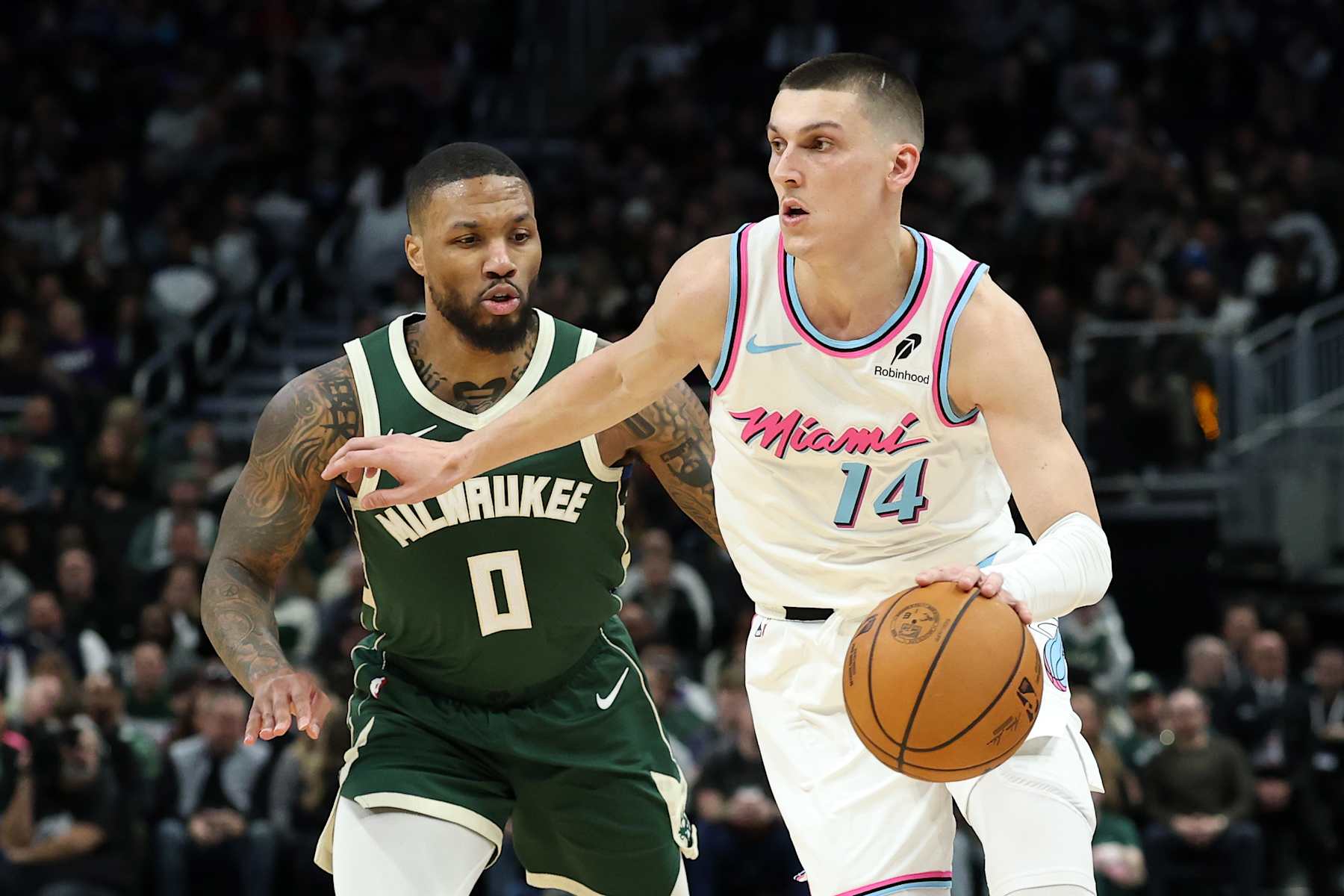 MILWAUKEE, WISCONSIN - JANUARY 23: Tyler Herro #14 of the Miami Heat is defended by Damian Lillard #0 of the Milwaukee Bucks during a game at Fiserv Forum on January 23, 2025 in Milwaukee, Wisconsin. NOTE TO USER: User expressly acknowledges and agrees that, by downloading and or using this photograph, User is consenting to the terms and conditions of the Getty Images License Agreement. (Photo by Stacy Revere/Getty Images)