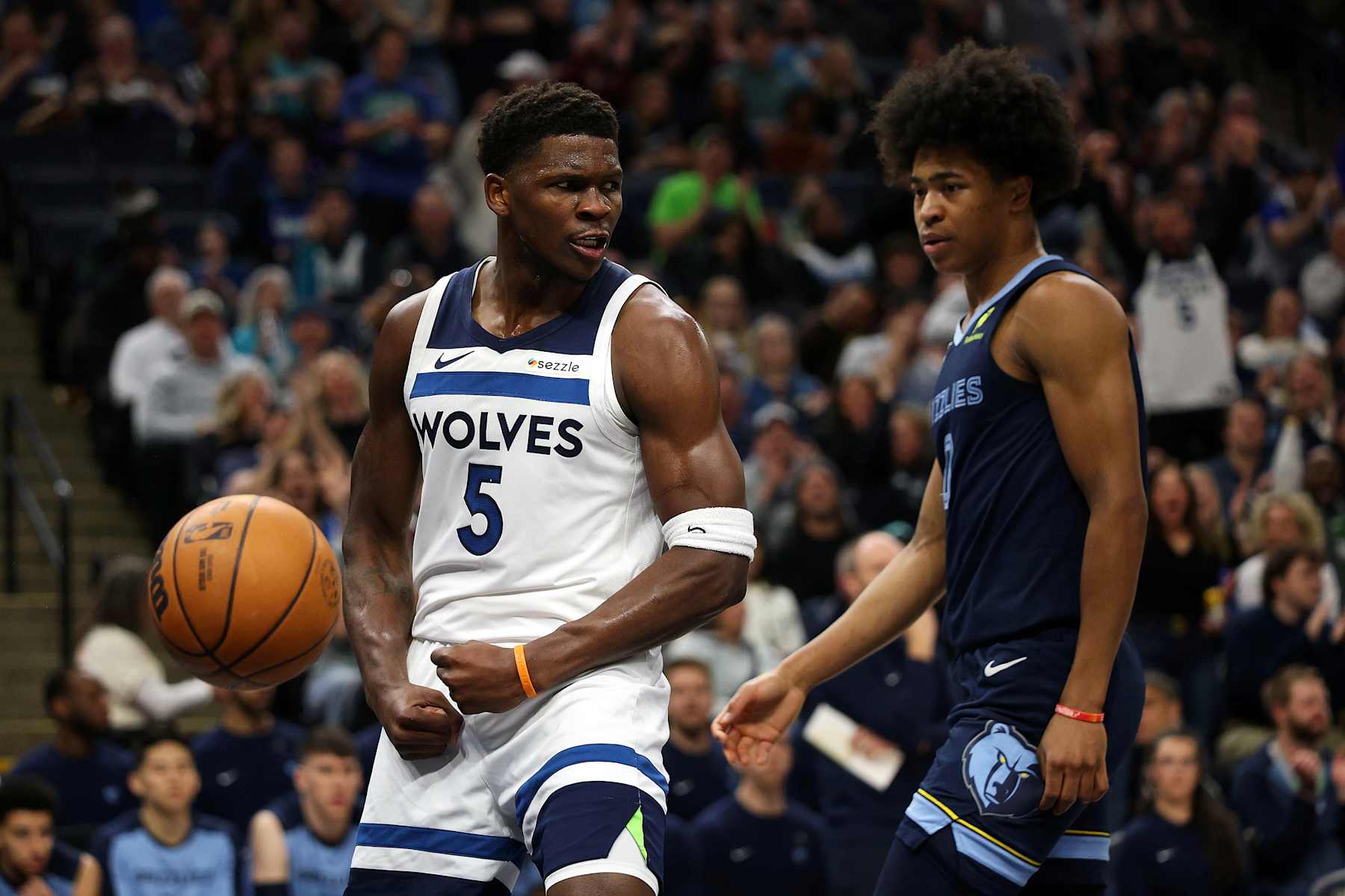 MINNEAPOLIS, MINNESOTA - JANUARY 11: Anthony Edwards #5 of the Minnesota Timberwolves celebrates his dunk as Jaylen Wells #0 of the Memphis Grizzlies looks on in the first quarter at Target Center on January 11, 2025 in Minneapolis, Minnesota. NOTE TO USER: User expressly acknowledges and agrees that, by downloading and or using this photograph, User is consenting to the terms and conditions of the Getty Images License Agreement. (Photo by David Berding/Getty Images)