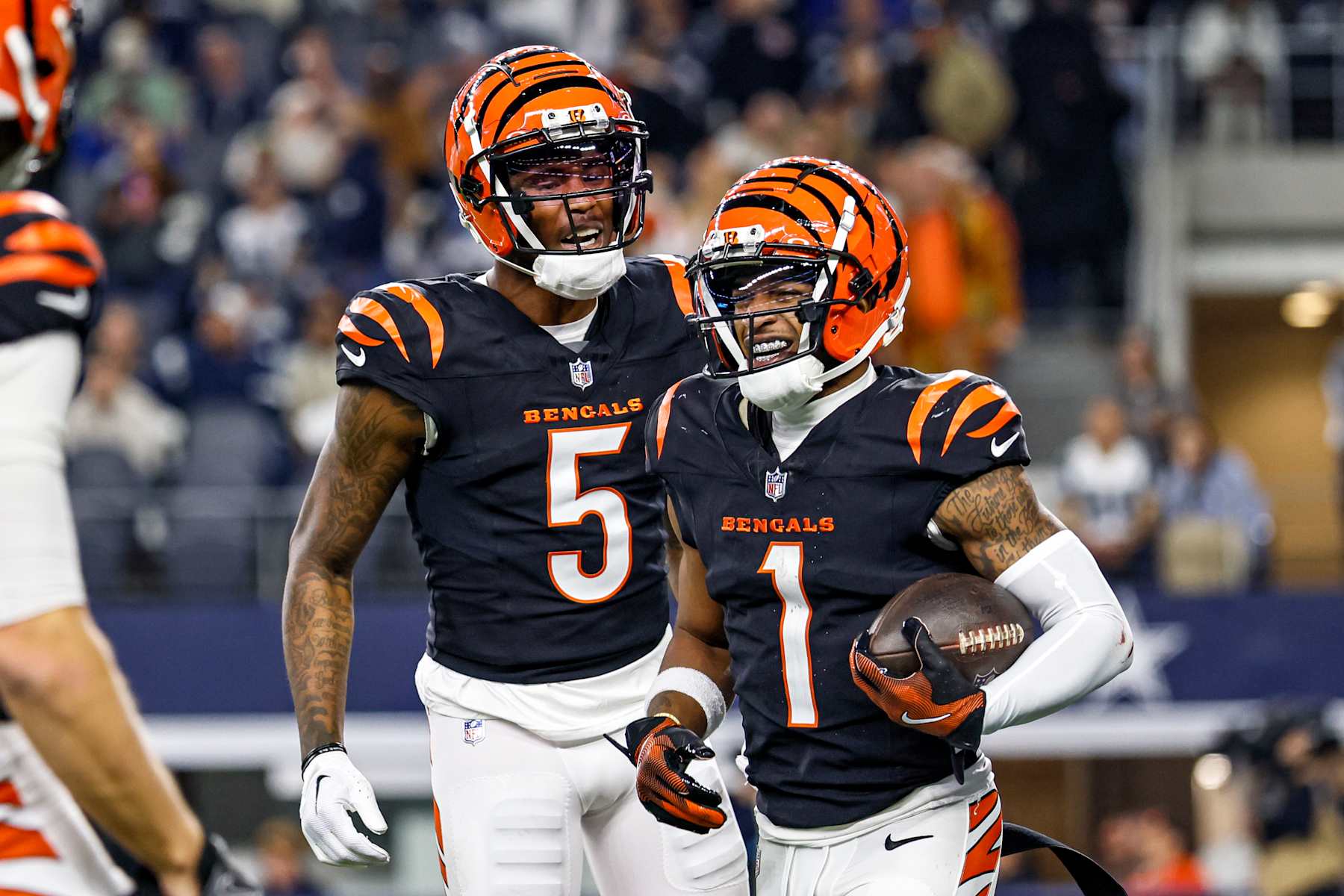 ARLINGTON, TX - DECEMBER 09: Cincinnati Bengals wide receiver Ja'Marr Chase (1) celebrates with wide receiver Tee Higgins (5) after a touchdown during the game between the Dallas Cowboys and the Cincinnati Bengals on December 9, 2024 at AT&T Stadium in Arlington, Texas. (Photo by Matthew Pearce/Icon Sportswire via Getty Images)