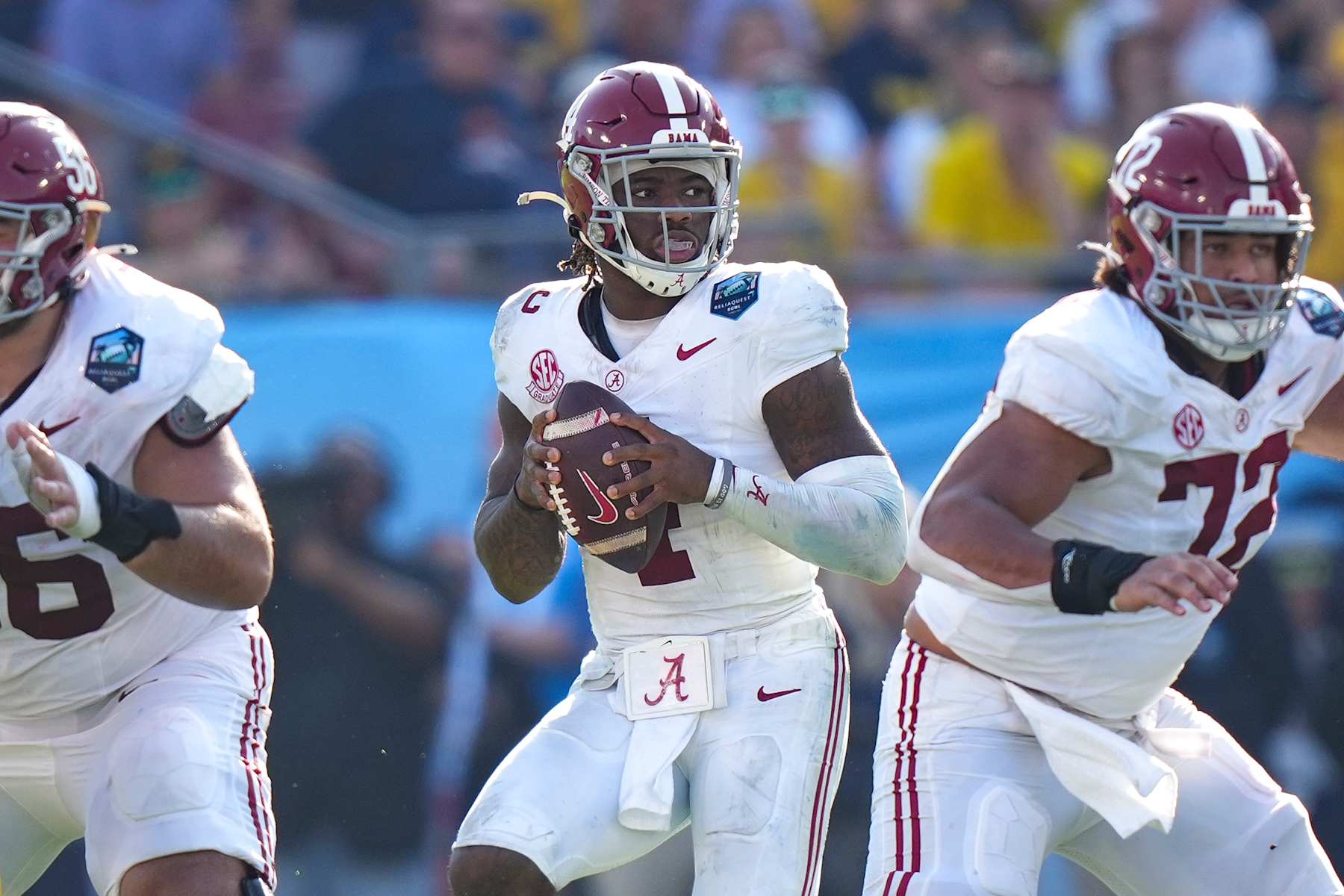 TAMPA, FL - DECEMBER 31: Alabama Crimson Tide quarterback Jalen Milroe (4) looks for an open receiver from the pocket during the ReliaQuest Bowl game between the Michigan Wolverines and the Alabama Crimson Tide on Tuesday, December 31, 2024 at Raymond James Stadium in Tampa, Fla. (Photo by Peter Joneleit/Icon Sportswire via Getty Images)