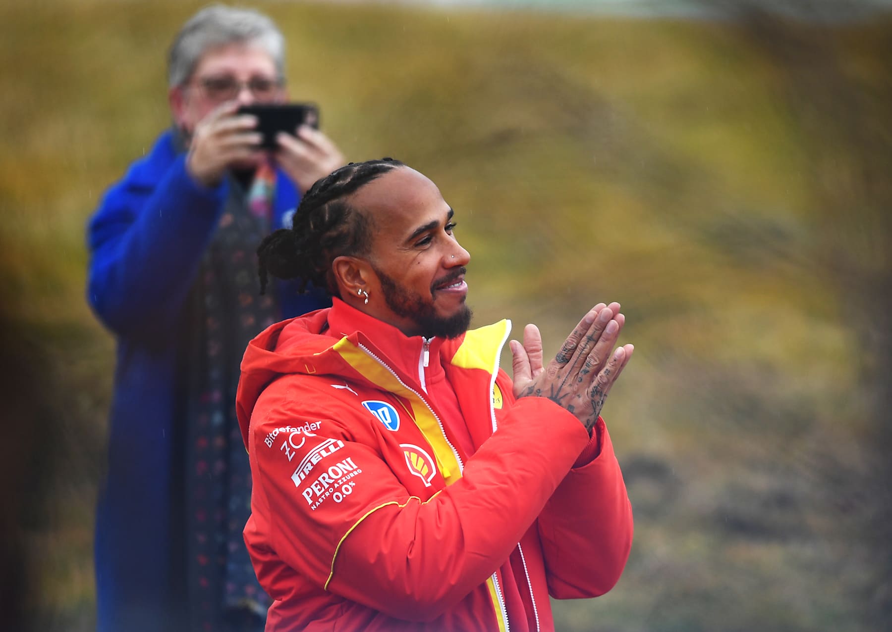 FIORANO MODENESE, ITALY - JANUARY 22: Lewis Hamilton of Great Britain and Ferrari greets the crowd during his first official days as a Scuderia Ferrari F1 driver at Fiorano Circuit on January 22, 2025 in Fiorano Modenese, Italy. (Photo by Rudy Carezzevoli/Getty Images)