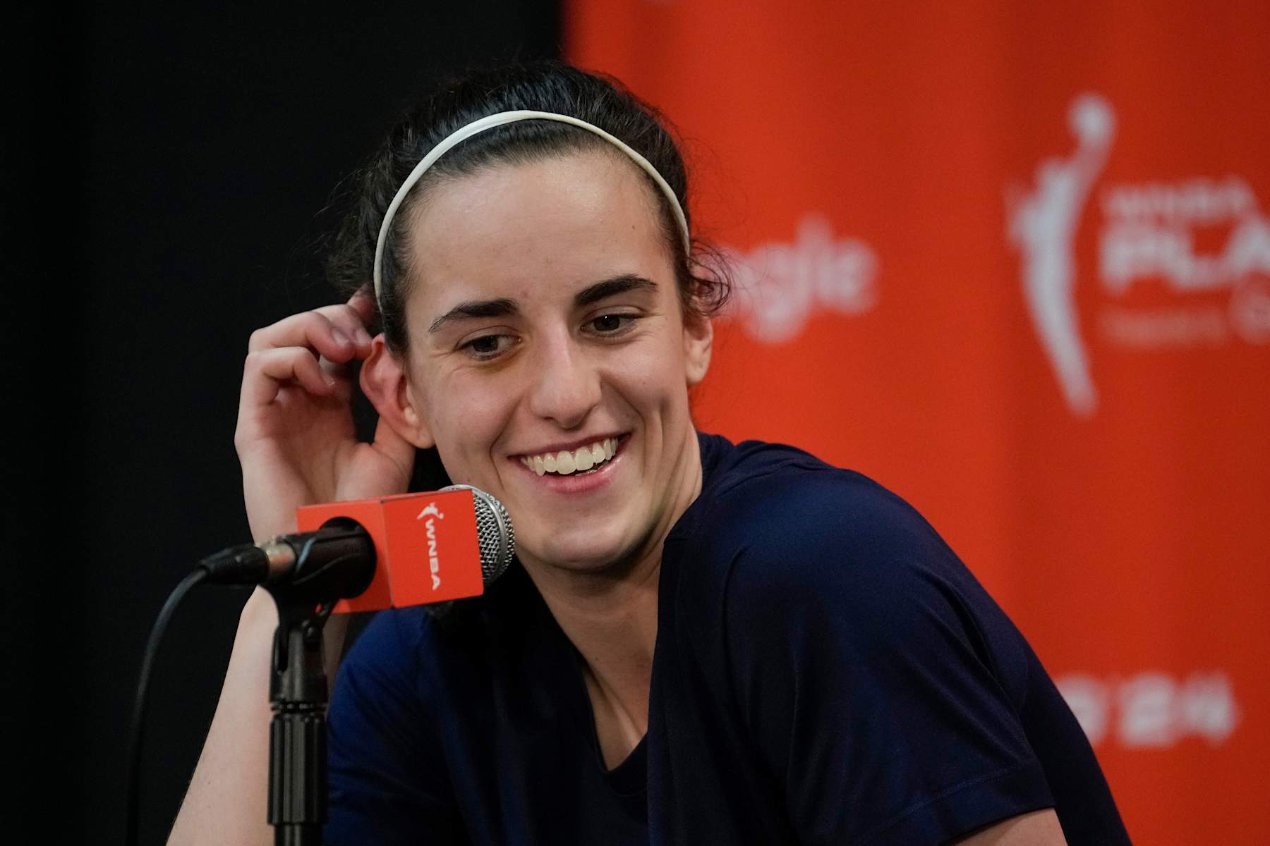 UNCASVILLE, CONNECTICUT - SEPTEMBER 25: Caitlin Clark #22 of the Indiana Fever smiles during a press conference after losing 81-87 to the Connecticut Sun in Game Two of the 2024 WNBA Playoffs first round at Mohegan Sun Arena on September 25, 2024 in Uncasville, Connecticut. (Photo by Joe Buglewicz/Getty Images)