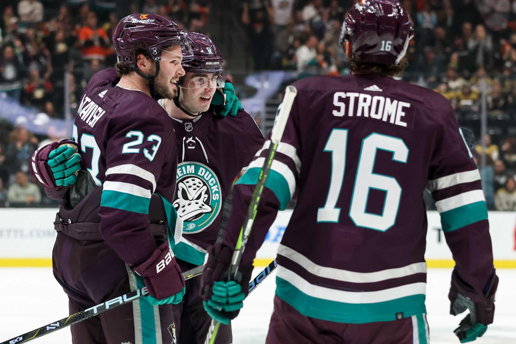 ANAHEIM, CA DECEMBER 27: Mason McTavish #23, Jamie Drysdale #6, and Ryan Strome #16 of the Anaheim Ducks celebrate a first period goal during the game against the Vegas Golden Knights on December 27, 2023 at Honda Center in Anaheim, California. (Photo by Debora Robinson NHLI via Getty Images)