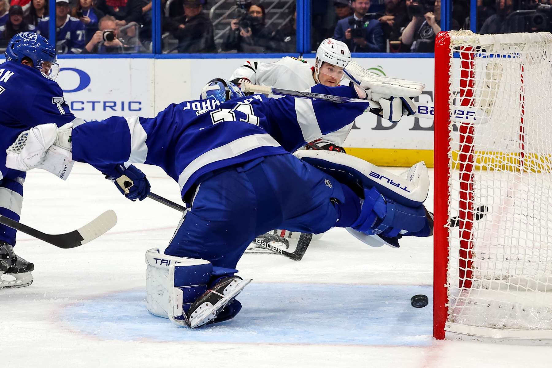 TAMPA, FL - JANUARY 28: Ryan Donato #8 of the Chicago Blackhawks scores past Jonas Johansson #31 of the Tampa Bay Lightning during the third period at the Amalie Arena on January 28, 2025 in Tampa, Florida. (Photo by Mike Carlson/Getty Images)
