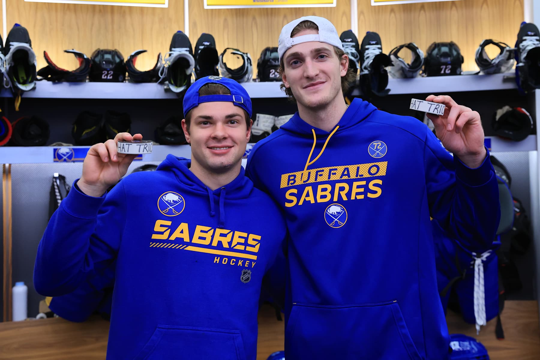 BUFFALO, NEW YORK - JANUARY 28: JJ Peterka (L) and Tage Thompson of the Buffalo Sabres pose with pucks after each scoring hat-tricks in an NHL game against the Boston Bruins on January 28, 2025 at KeyBank Center in Buffalo, New York. Buffalo won, 7-2. (Photo by Bill Wippert/NHLI via Getty Images)
