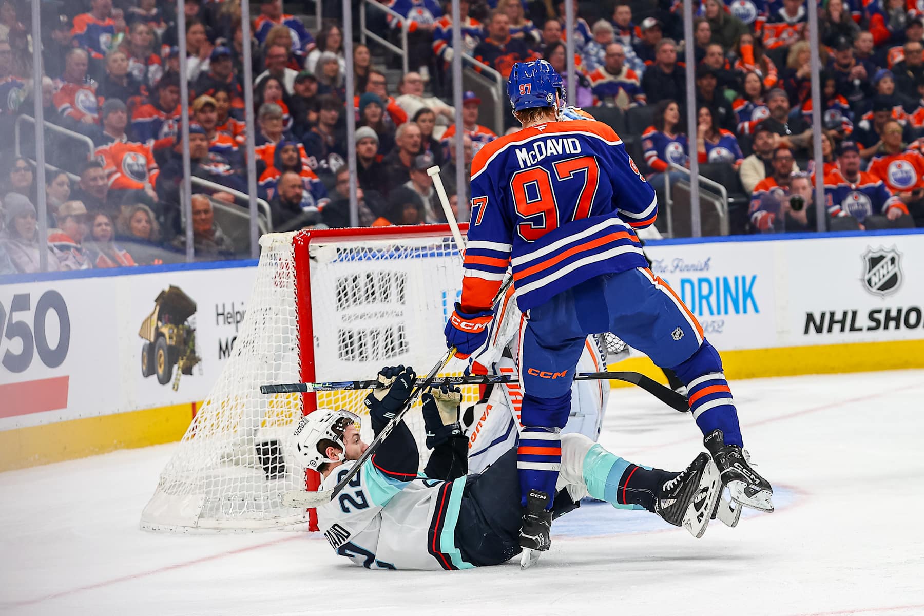 EDMONTON, AB - JANUARY 27 Edmonton Oilers Center Connor McDavid (97) hits Seattle Kraken Defenceman Joshua Mahura (28) in the second period of the Edmonton Oilers game versus the Seattle Kraken on January 27, 2025 at Rogers Place in Edmonton, AB. (Photo by Curtis Comeau/Icon Sportswire via Getty Images)