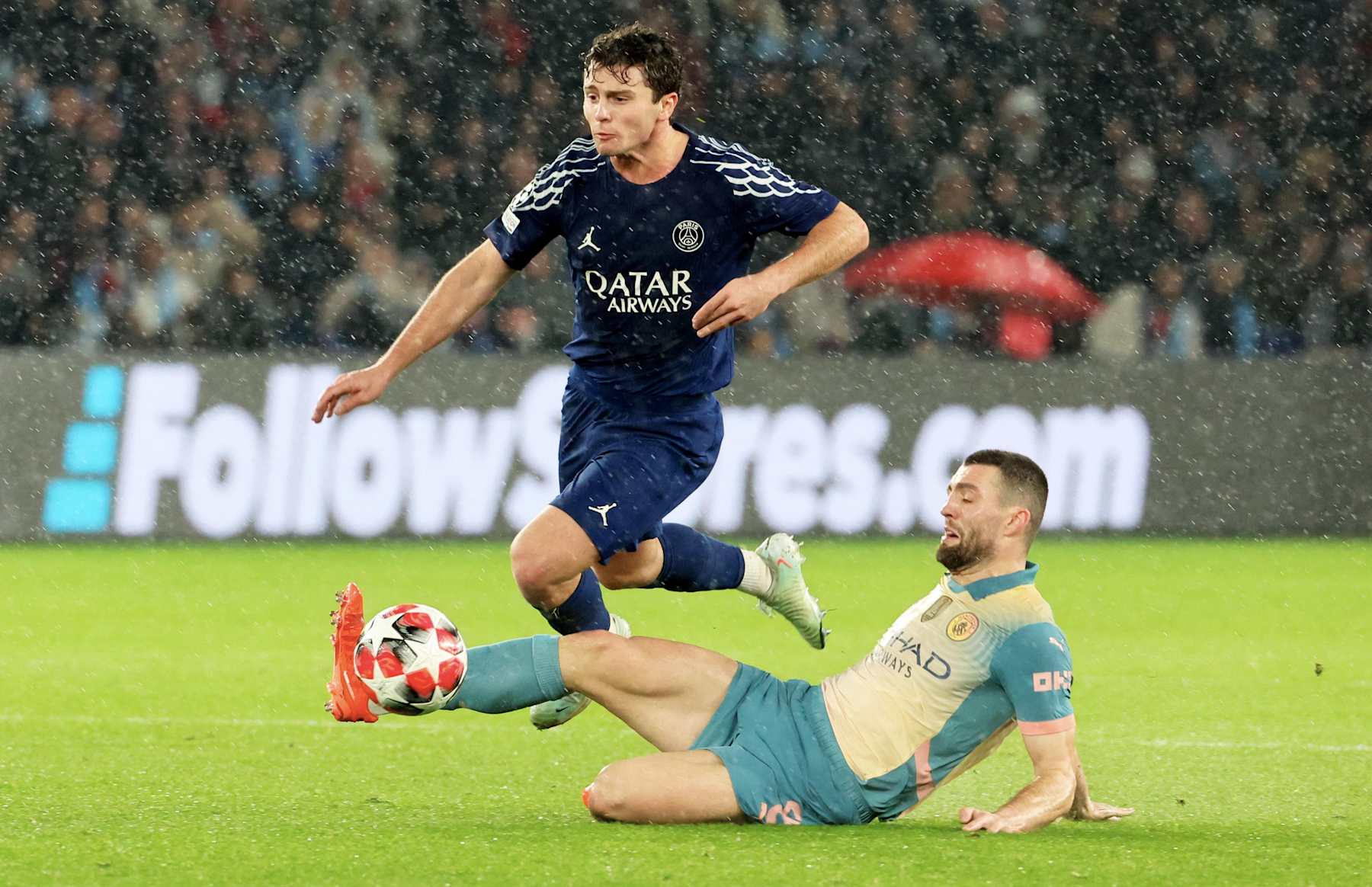 PARIS, FRANCE - JANUARY 22: Joao Neves #87 of Paris Saint-Germain is tackle by Mateo Kovacic #8 of Manchester City during the UEFA Champions League 2024/25 League Phase MD7 match between Paris Saint-Germain and Manchester City at Parc des Princes on January 22, 2025 in Paris, France. (Photo by Xavier Laine/Getty Images)