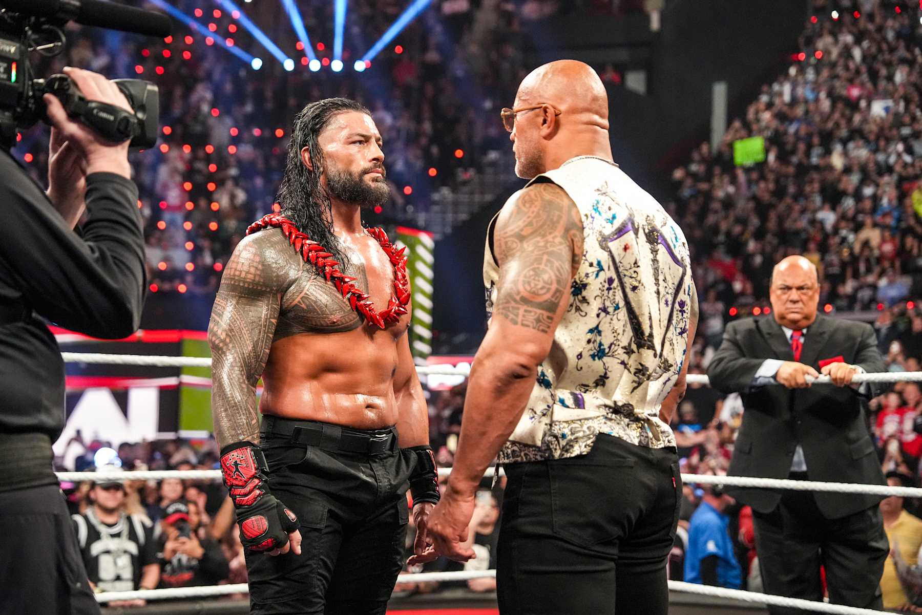 INGLEWOOD, CALIFORNIA - JANUARY 6: Roman Reigns and Dwayne "The Rock" Johnson face-off during RAW at Intuit Dome on January 6, 2025 in Inglewood, California. (Photo by WWE/Getty Images)
