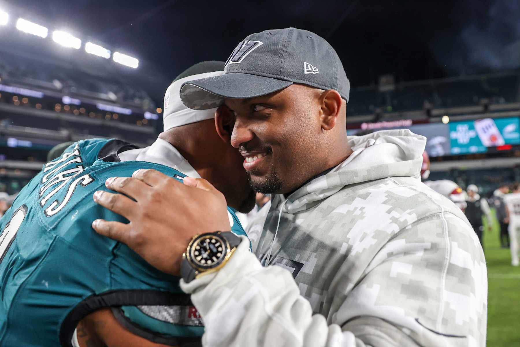 PHILADELPHIA, PENNSYLVANIA - NOVEMBER 14: Jalen Hurts #1 of the Philadelphia Eagles hugs Brian Johnson, assistant head coach and offensive pass game coordinator of the Washington Commanders after the game at Lincoln Financial Field on November 14, 2024 in Philadelphia, Pennsylvania. The Eagles won 26-18. (Photo by Elsa/Getty Images)