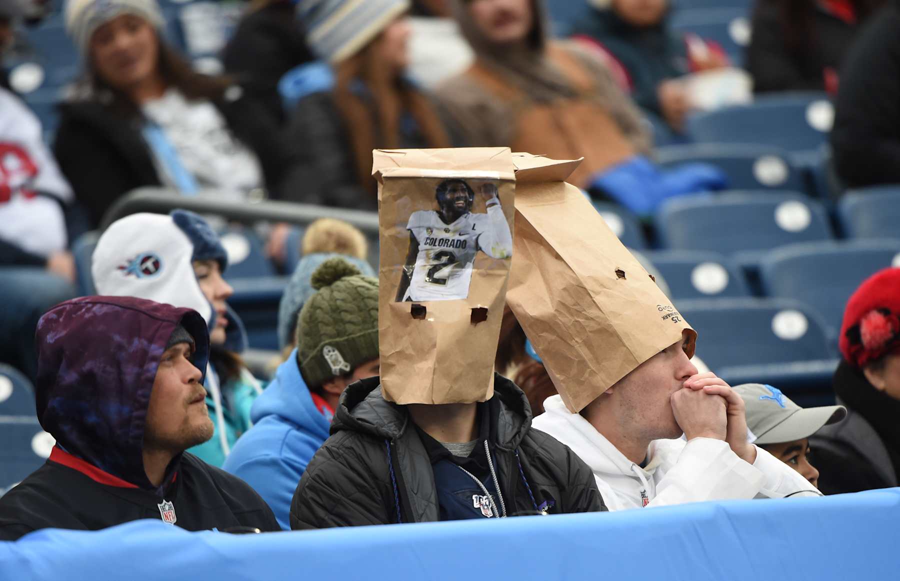 NASHVILLE, TN - JANUARY 5: Tennessee Titans fans wear paper bags featuring Shedeur Sanders during game featuring the Houston Texans and the Tennessee Titans on January 5, 2025 at Nissan Stadium in Nashville, TN. (Photo by John Rivera/Icon Sportswire via Getty Images)