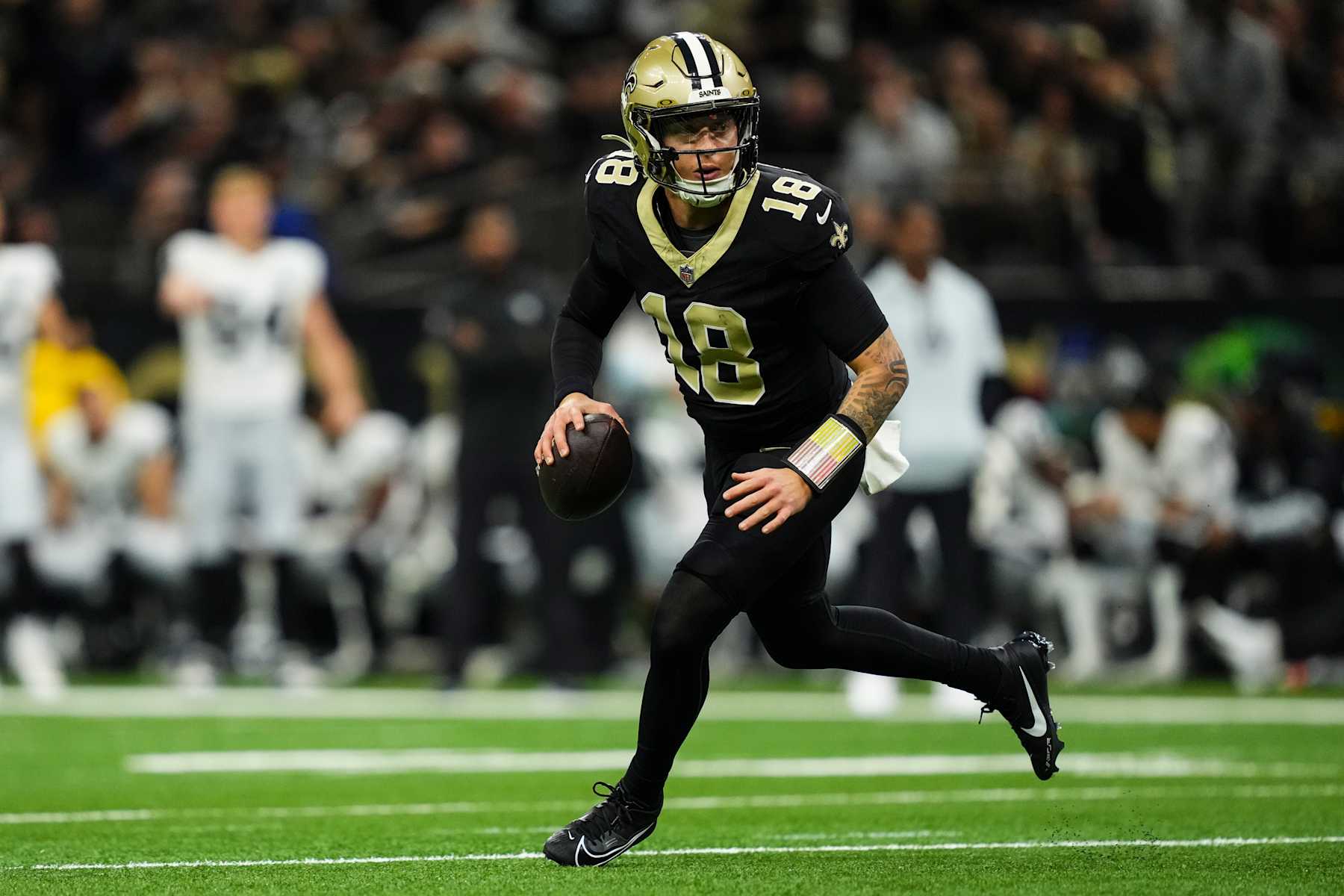 NEW ORLEANS, LA - DECEMBER 29: Spencer Rattler #18 of the New Orleans Saints scrambles out of the pocket during an NFL football game against the Las Vegas Raiders at Caesars Superdome on December 29, 2024 in New Orleans, Louisiana. (Photo by Cooper Neill/Getty Images)