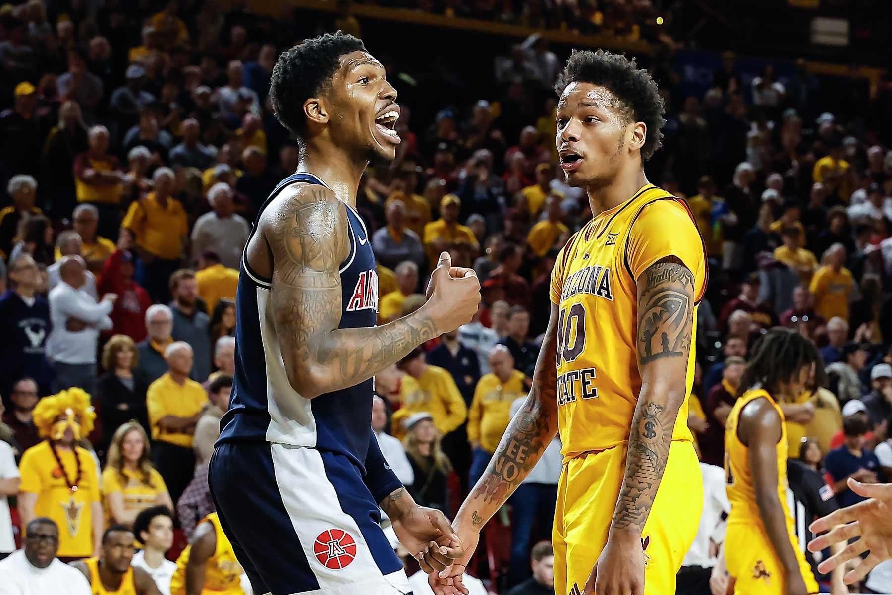 SCOTTSDALE, AZ - FEBRUARY 01: Arizona Wildcats guard Caleb Love (1) and Arizona State Sun Devils guard BJ Freeman (10) trash talk each other during the college basketball game between the Arizona Wildcats and the Arizona State Sun Devils on February 1, 2025 at Desert Financial Arena in Tempe, Arizona. (Photo by Kevin Abele/Icon Sportswire via Getty Images)
