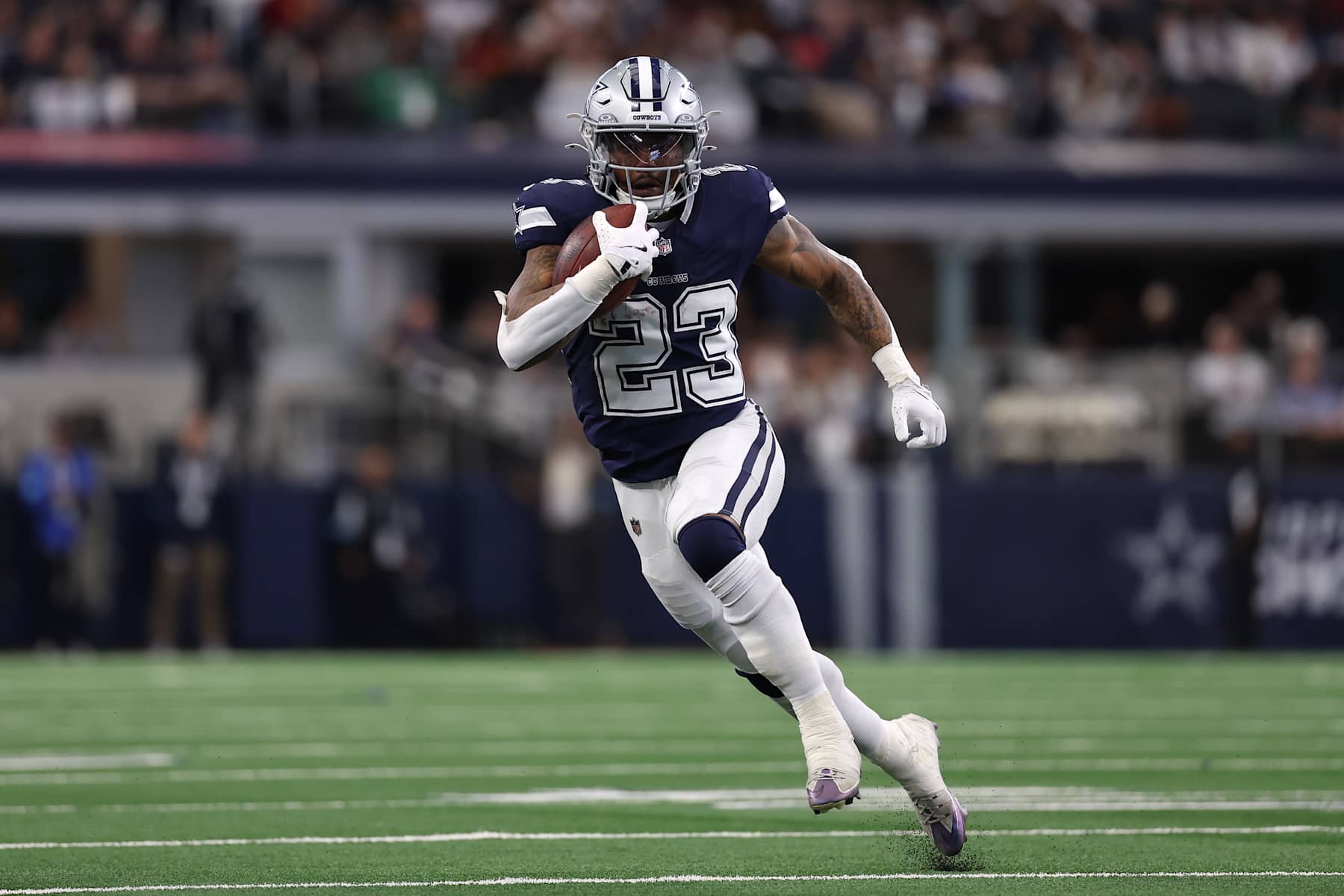 ARLINGTON, TEXAS - JANUARY 05: Rico Dowdle #23 of the Dallas Cowboys runs with the ball during the second quarter against the Washington Commanders at AT&T Stadium on January 05, 2025 in Arlington, Texas. (Photo by Sam Hodde/Getty Images)