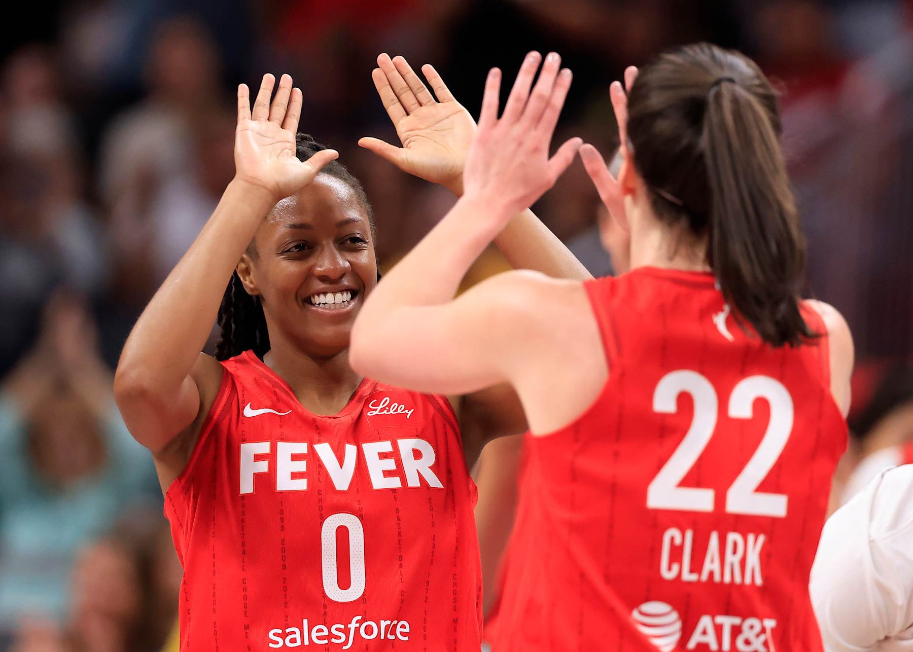 INDIANAPOLIS, INDIANA - AUGUST 16: Kelsey Mitchell #0 of the Indiana Fever celebrates with Caitlin Clark #22 of the Indiana Fever during the first half against the Phoenix Mercury at Gainbridge Fieldhouse on August 16, 2024 in Indianapolis, Indiana. (Photo by Justin Casterline/Getty Images)