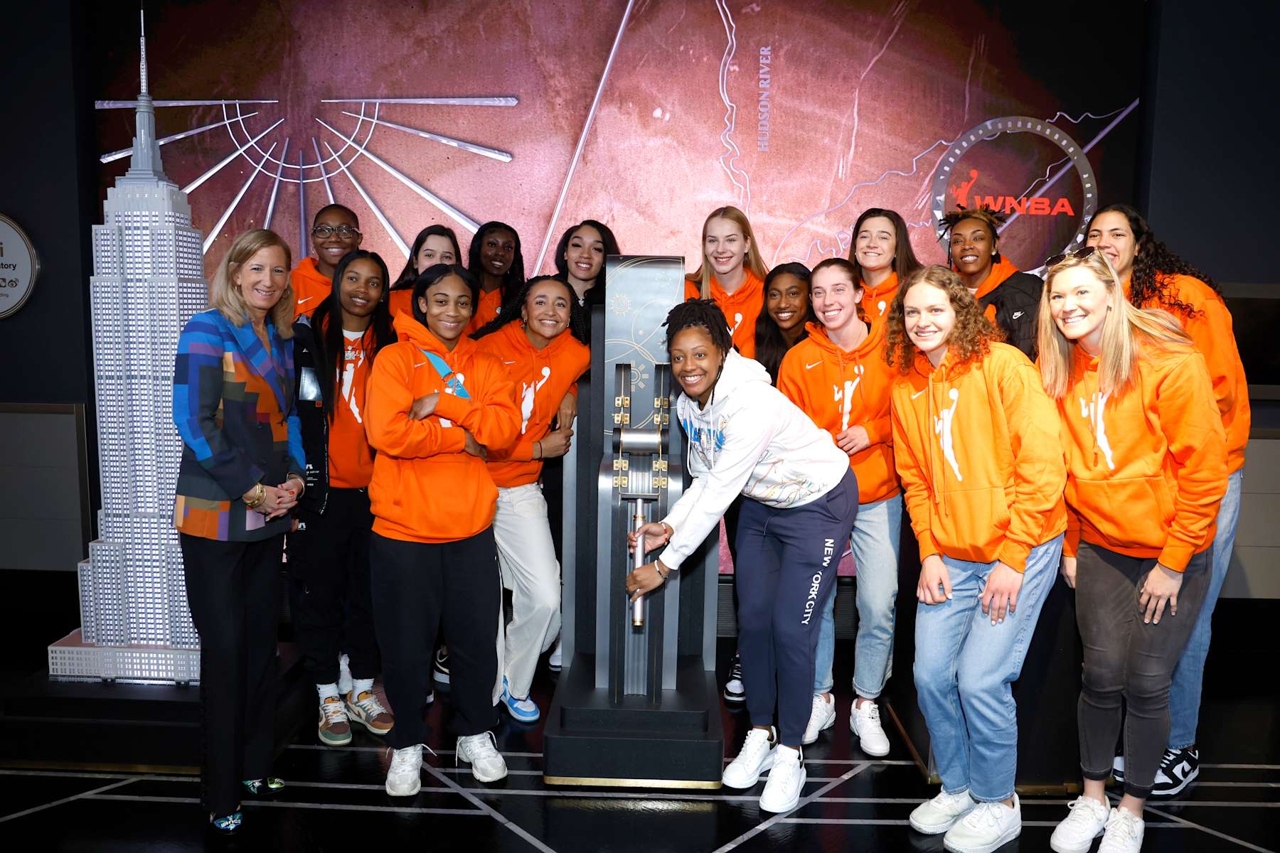 NEW YORK, NEW YORK - APRIL 10: WNBA Commissioner Cathy Engelbert (L), Kelsey Mitchell (center R) & WNBA Draftees Alexis Morris, Aliyah Boston, Zia Cooke, Lou Lopez Senechal, Haley Jones, Laeticia Amihere, Brea Beal, Dorka Juhasz, Diamond Miller, Taylor Mikesell, Grace Berger, Jordan Horston, Ashley Joens, and Stephanie Soares light the Empire State Building in celebration of the 2023 WNBA Draft at The Empire State Building on April 10, 2023 in New York City. (Photo by John Lamparski/Getty Images for Empire State Realty Trust)