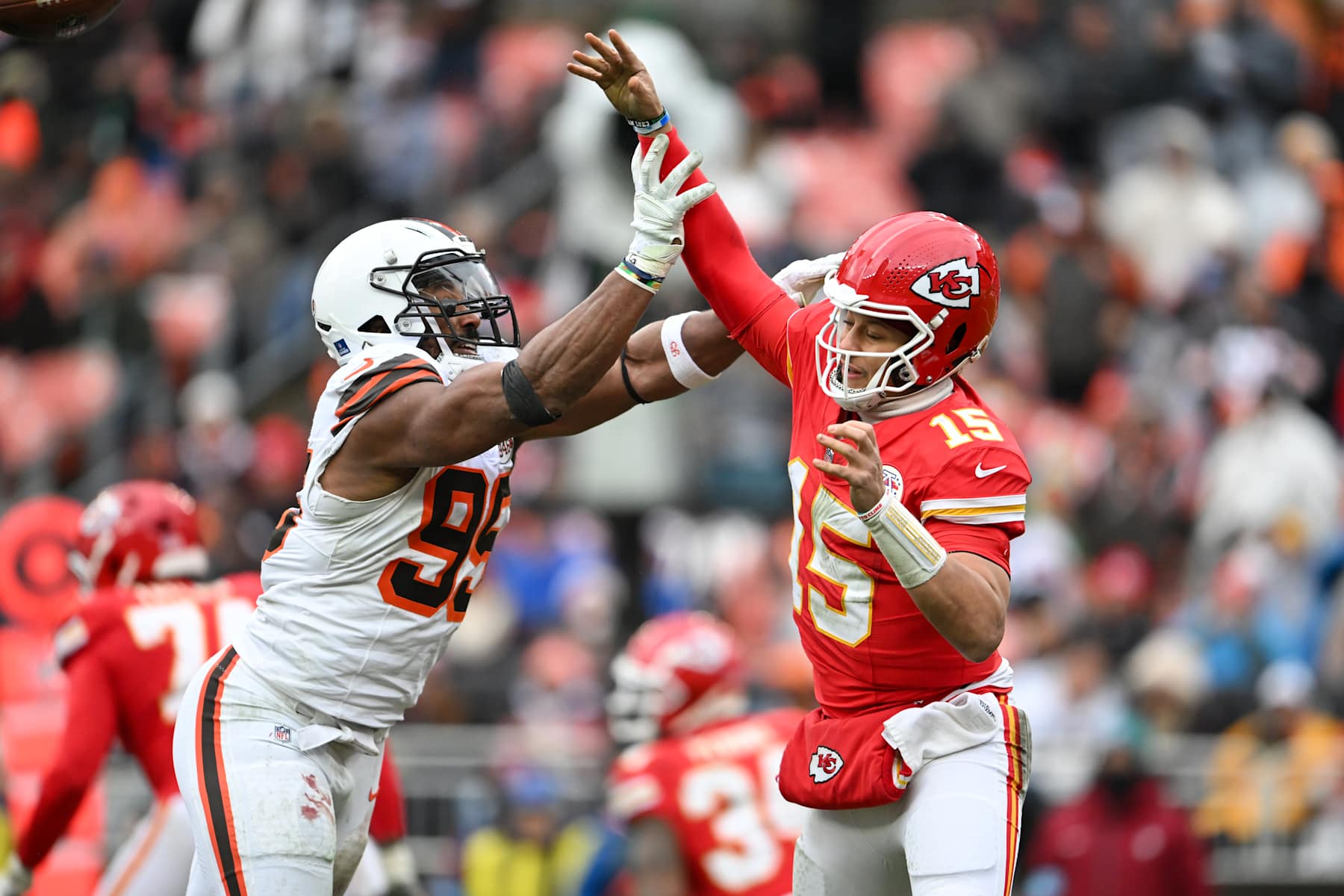 CLEVELAND, OHIO - DECEMBER 15: Patrick Mahomes #15 of the Kansas City Chiefs throws a pass as he is hit by Myles Garrett #95 of the Cleveland Browns during the third quarter at Huntington Bank Field on December 15, 2024 in Cleveland, Ohio. (Photo by Nick Cammett/Diamond Images via Getty Images)