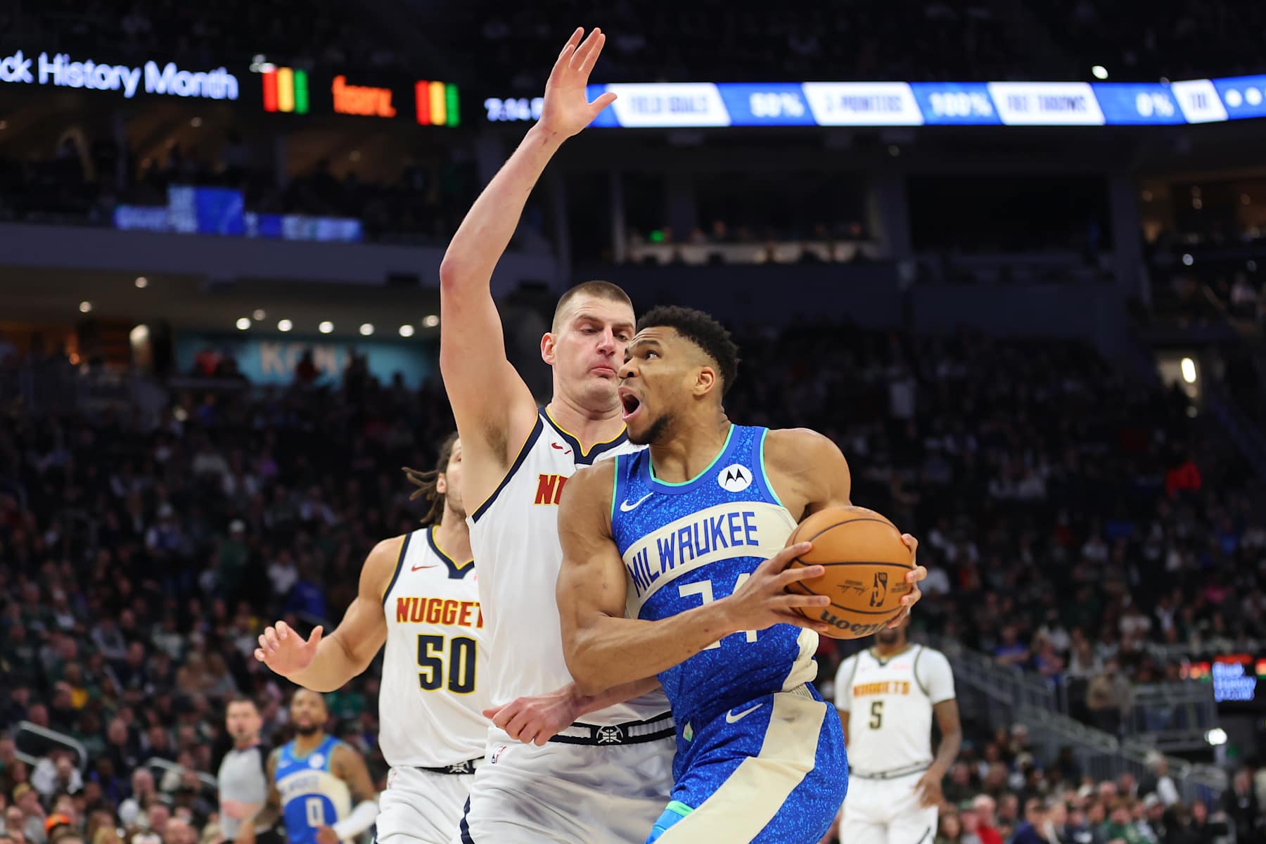 MILWAUKEE, WISCONSIN - FEBRUARY 12: Giannis Antetokounmpo #34 of the Milwaukee Bucks is defended by Nikola Jokic #15 of the Denver Nuggets during a game at Fiserv Forum on February 12, 2024 in Milwaukee, Wisconsin. NOTE TO USER: User expressly acknowledges and agrees that, by downloading and or using this photograph, User is consenting to the terms and conditions of the Getty Images License Agreement. (Photo by Stacy Revere/Getty Images)