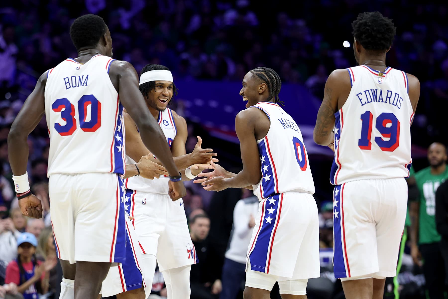 PHILADELPHIA, PENNSYLVANIA - FEBRUARY 02: Tyrese Maxey #0 of the Philadelphia 76ers celebrates his three-pointer with Adem Bona #30, Ricky Council IV #14 and Justin Edwards #19 during the first half against the Boston Celtics at the Wells Fargo Center on February 02, 2025 in Philadelphia, Pennsylvania. NOTE TO USER: User expressly acknowledges and agrees that, by downloading and or using this photograph, User is consenting to the terms and conditions of the Getty Images License Agreement. (Photo by Emilee Chinn/Getty Images)