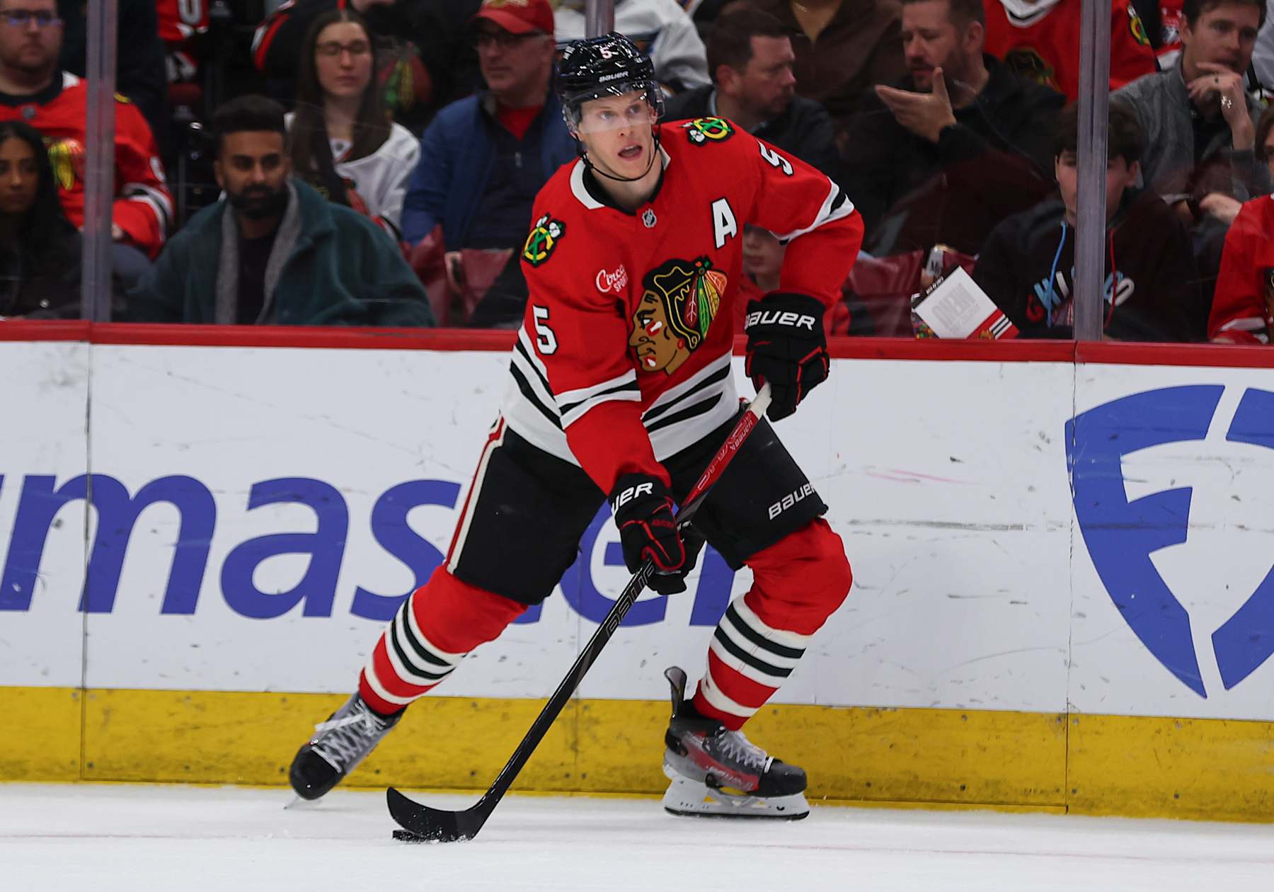 CHICAGO, IL - DECEMBER 17: Connor Murphy #5 of the Chicago Blackhawks controls the puck during the second period against the Washington Capitals on December 17, 2024 at the United Center in Chicago, Illinois. (Photo by Melissa Tamez/Icon Sportswire via Getty Images)