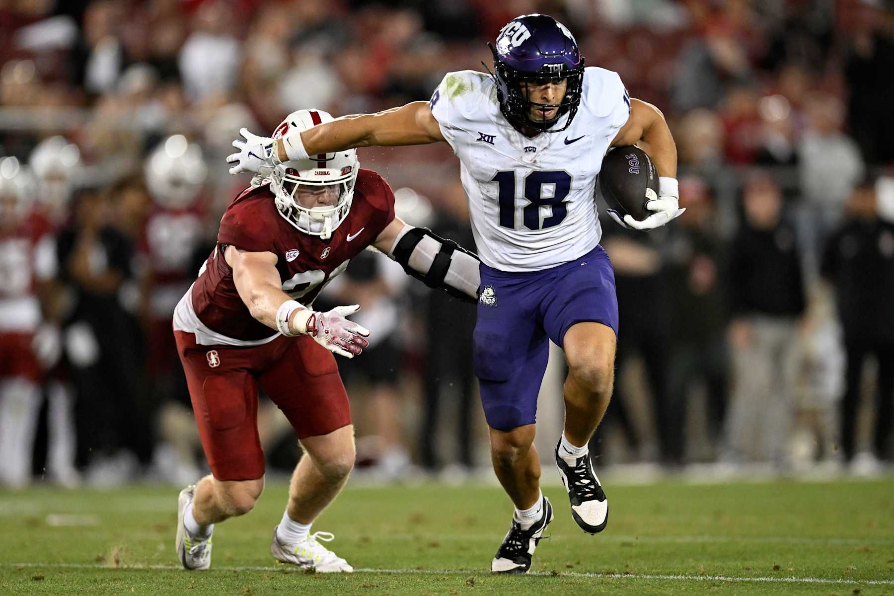 STANFORD, CALIFORNIA - AUGUST 30: Jack Bech #18 of the TCU Horned Frogs holds off Scotty Edwards #21 of the Stanford Cardinal in the third quarter at Stanford Stadium on August 30, 2024 in Stanford, California. (Photo by Eakin Howard/Getty Images)