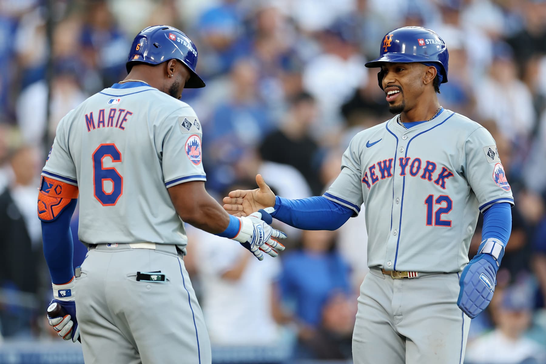 LOS ANGELES, CALIFORNIA - OCTOBER 20:  Francisco Lindor #12 of the New York Mets celebrates with Starling Marte #6 after scoring during the 1st inning of Game Six of the National League Championship Series against the Los Angeles Dodgers at Dodger Stadium on October 20, 2024 in Los Angeles, California. (Photo by Harry How/Getty Images)