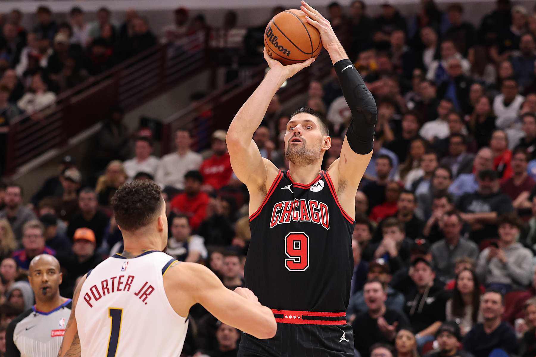 CHICAGO, ILLINOIS - JANUARY 27: Nikola Vucevic #9 of the Chicago Bulls shoots over Michael Porter Jr. #1 of the Denver Nuggets during the second half at the United Center on January 27, 2025 in Chicago, Illinois. NOTE TO USER: User expressly acknowledges and agrees that, by downloading and or using this photograph, User is consenting to the terms and conditions of the Getty Images License Agreement. (Photo by Michael Reaves/Getty Images)