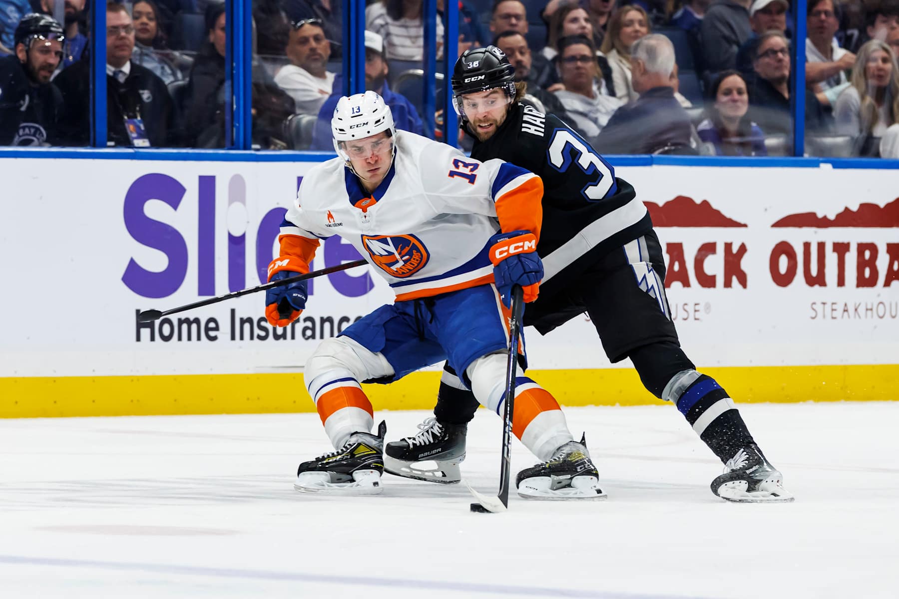 TAMPA, FL - FEBRUARY 1: Brandon Hagel #38 of the Tampa Bay Lightning battles against Mathew Barzal #13 of the New York Islanders at Amalie Arena on February 1, 2025 in Tampa, Florida. (Photo by Mark LoMoglio/NHLI via Getty Images)