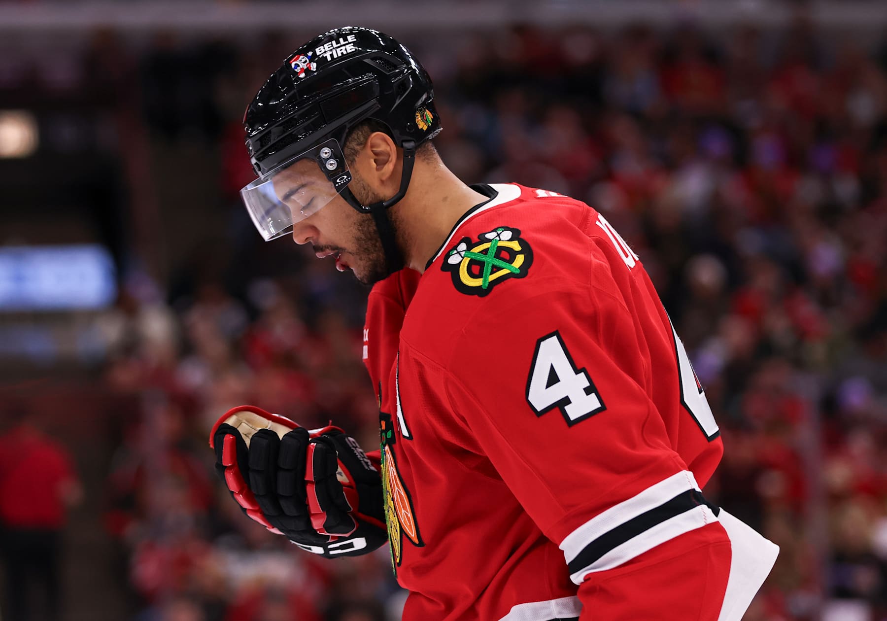 CHICAGO, IL - JANUARY 26: Seth Jones #4 of the Chicago Blackhawks bleeds from his mouth after a puck hit him during the second period against the Minnesota Wild on January 26, 2025 at the United Center in Chicago, Illinois. (Photo by Melissa Tamez/Icon Sportswire via Getty Images)