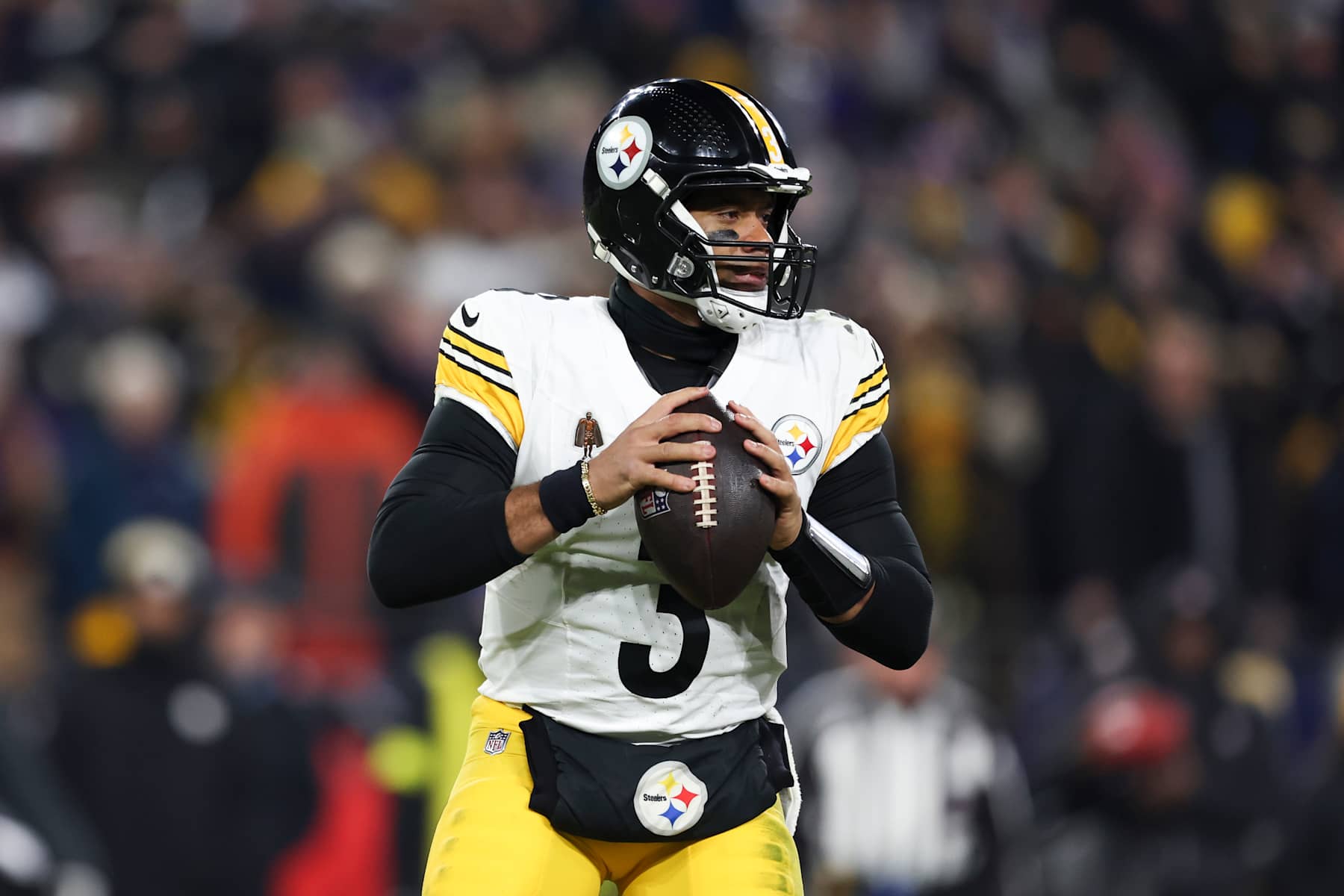 BALTIMORE, MARYLAND - JANUARY 11: Russell Wilson #3 of the Pittsburgh Steelers looks to make a pass during a Wild Card Playoff Game against the Baltimore Ravens at M&T Bank Stadium on January 11, 2025 in Baltimore, Maryland. The Ravens defeated the Steelers 28-14. (Kara Durrette/Getty Images)