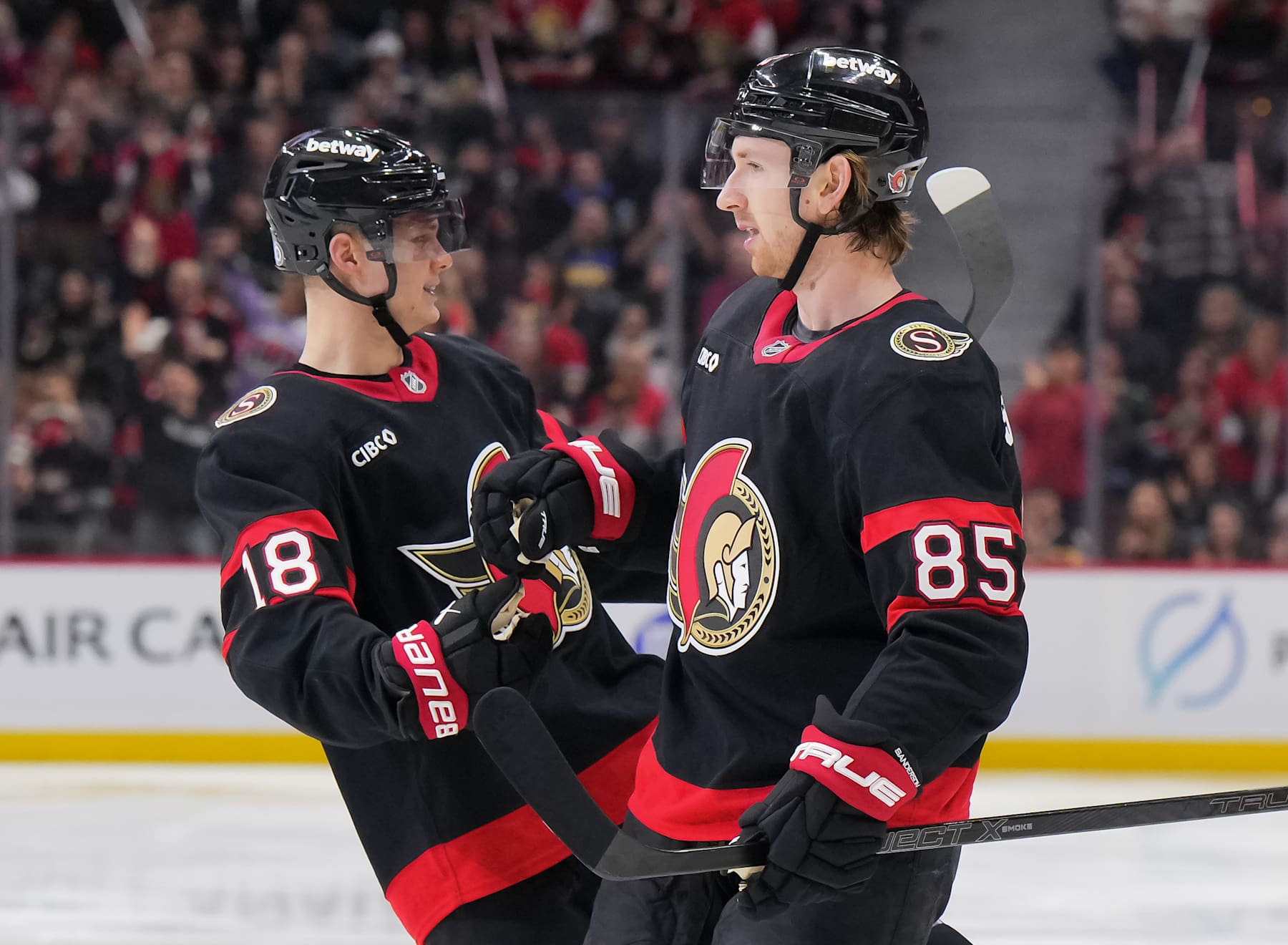 OTTAWA, CANADA - FEBRUARY 1: Jake Sanderson #85 of the Ottawa Senators celebrates his third period goal against the Minnesota Wild with teammate Tim Stützle #18 at Canadian Tire Centre on February 1, 2025 in Ottawa, Ontario, Canada. (Photo by André Ringuette/NHLI via Getty Images)