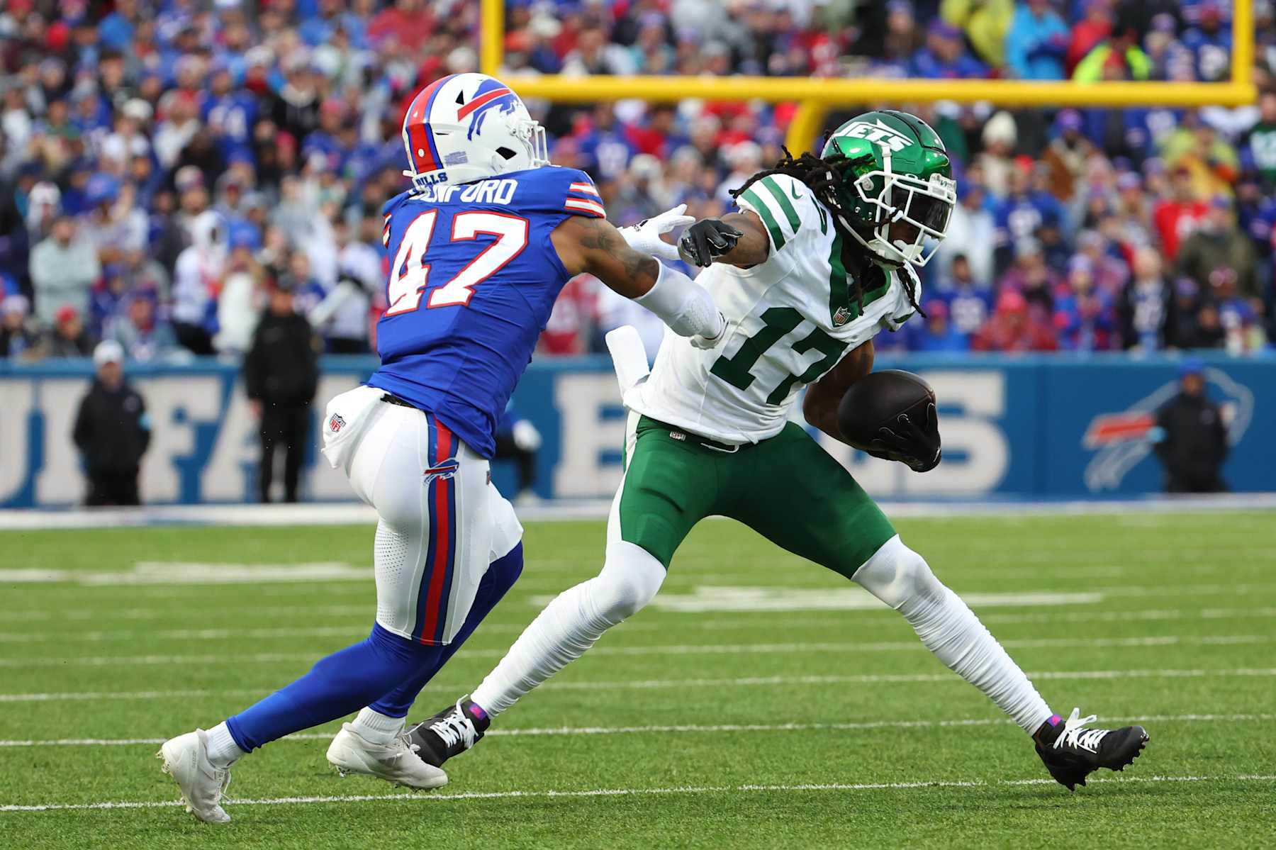 ORCHARD PARK, NEW YORK - DECEMBER 29: Davante Adams #17 of the New York Jets runs with the ball after a catch as Christian Benford #47 of the Buffalo Bills looks to make a tackle during the second quarter at Highmark Stadium on December 29, 2024 in Orchard Park, New York. (Photo by Timothy T Ludwig/Getty Images)